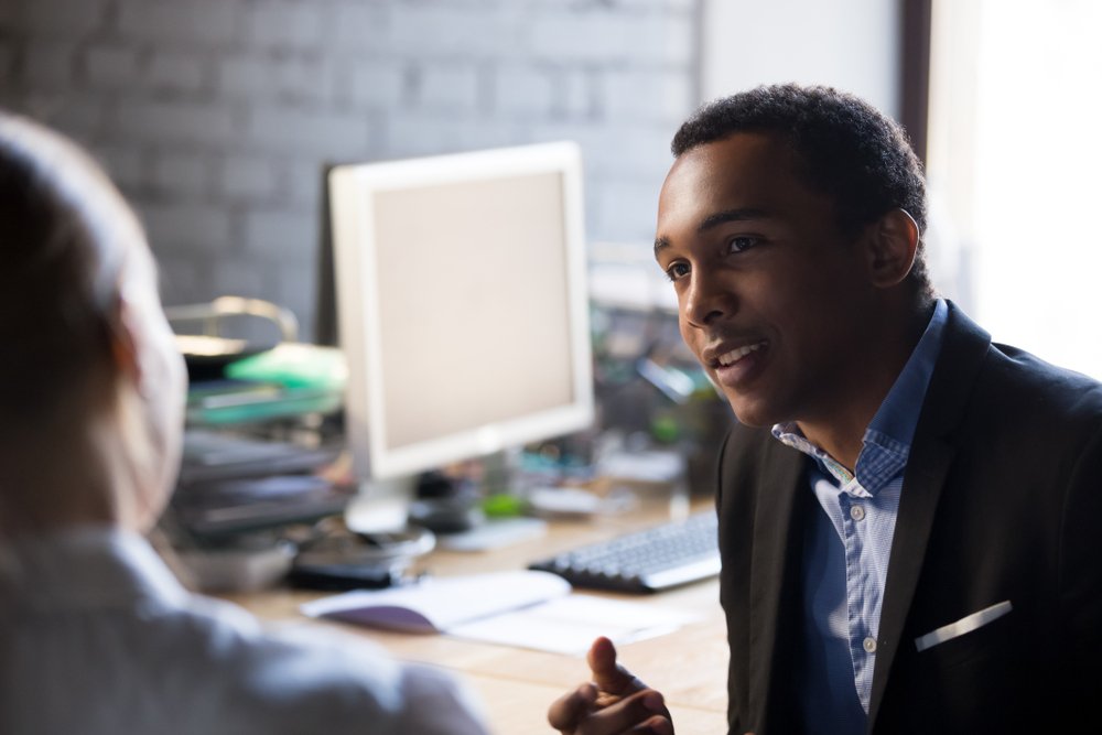 African CEO having conversation with company client | Photo:Shutterstock