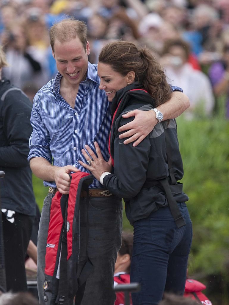 Prince William, Duke of Cambridge and Catherine, Duchess of Cambridge hug after taking part in a dragon boat race at Dalvay-by-the-sea on day 5 of the Royal Couple's North American Tour, July 4, 2011 | Photo: Getty Images