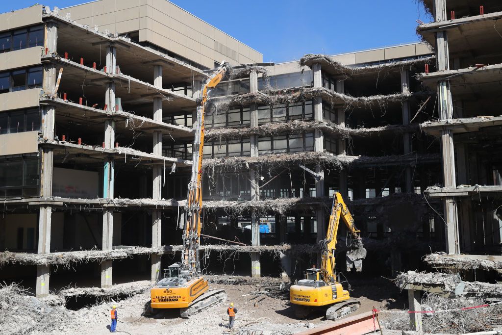  A Longfront excavator with demolition shears demolishes a multilevel office building in Germany. | Source: Getty Images