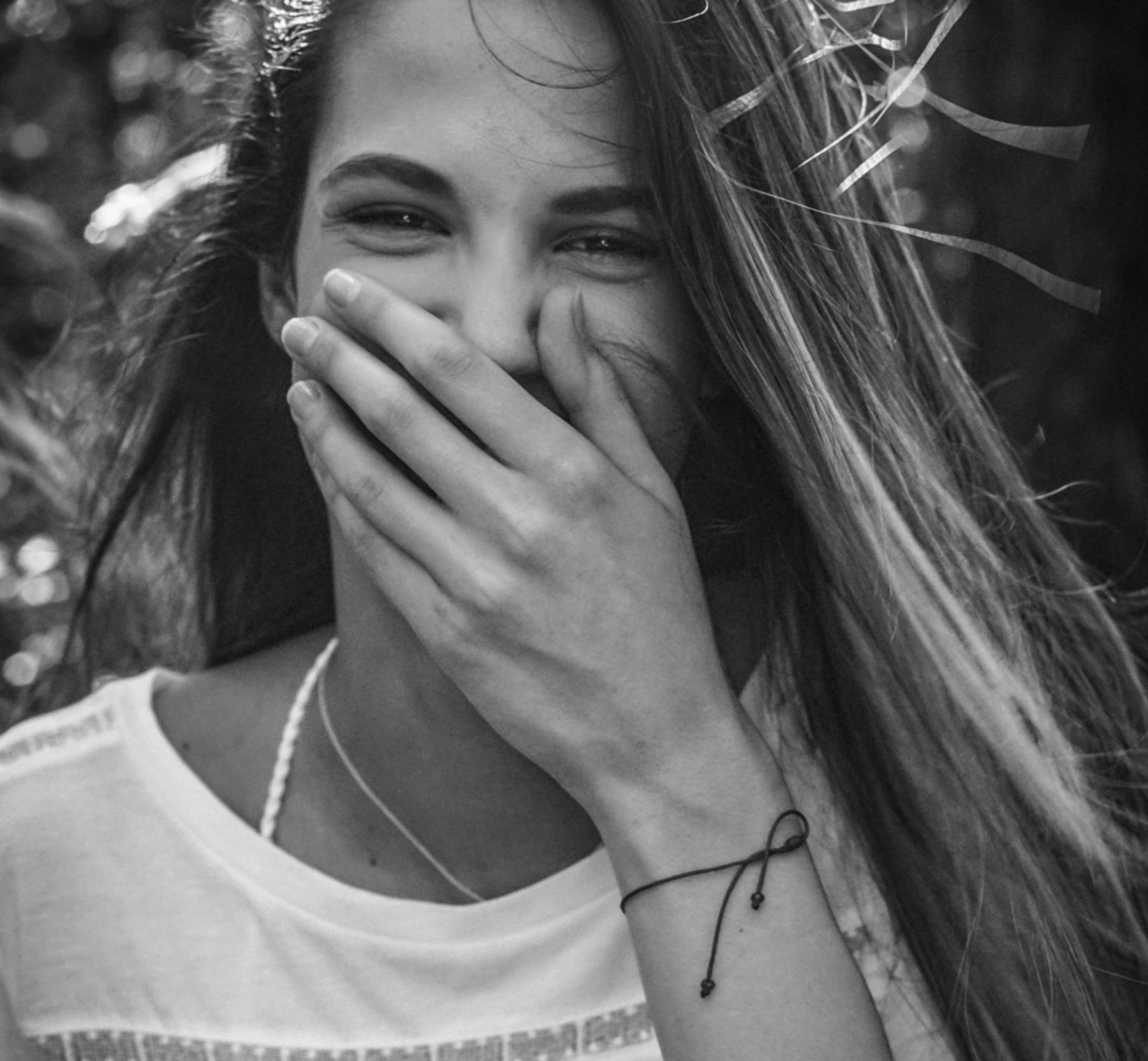 Happy woman covering her mouth | Source: Pexels