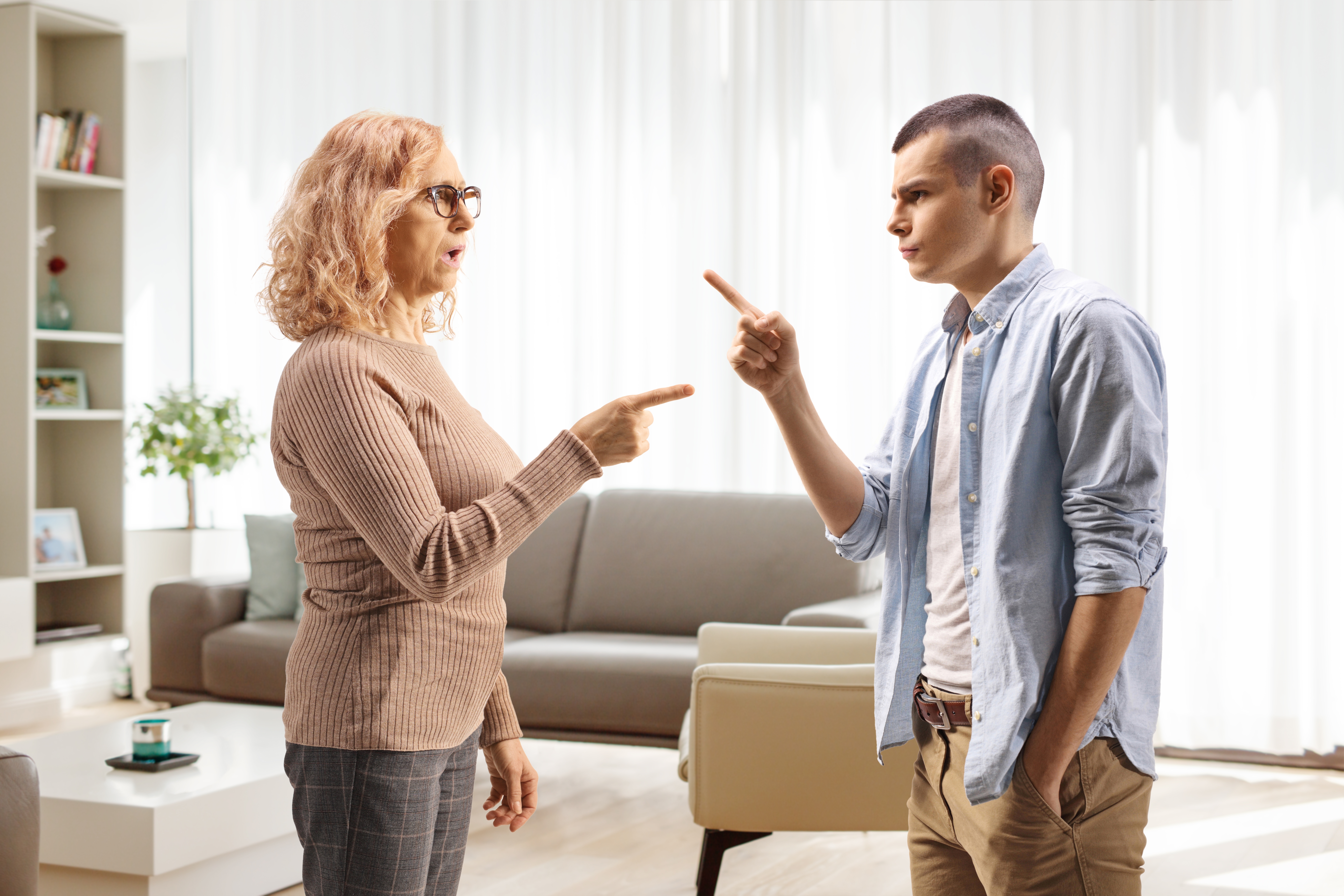 A mother arguing with her son at home | Source: Shutterstock