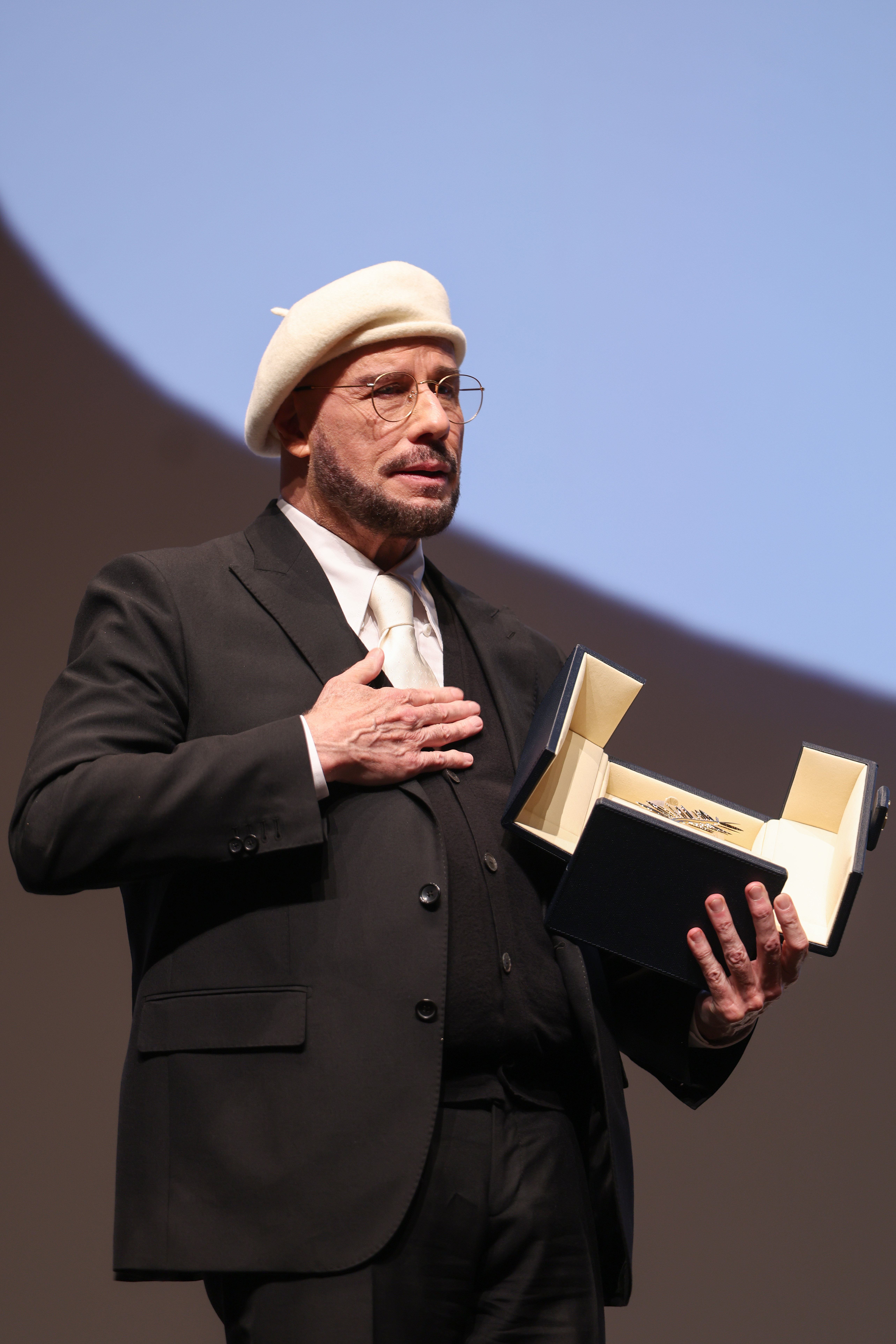 John Travolta accepts the Honorary Palme Award onstage during the annual Cannes Film Festival at Plage Macé on May 15, 2026, in Cannes, France | Source: Getty Images