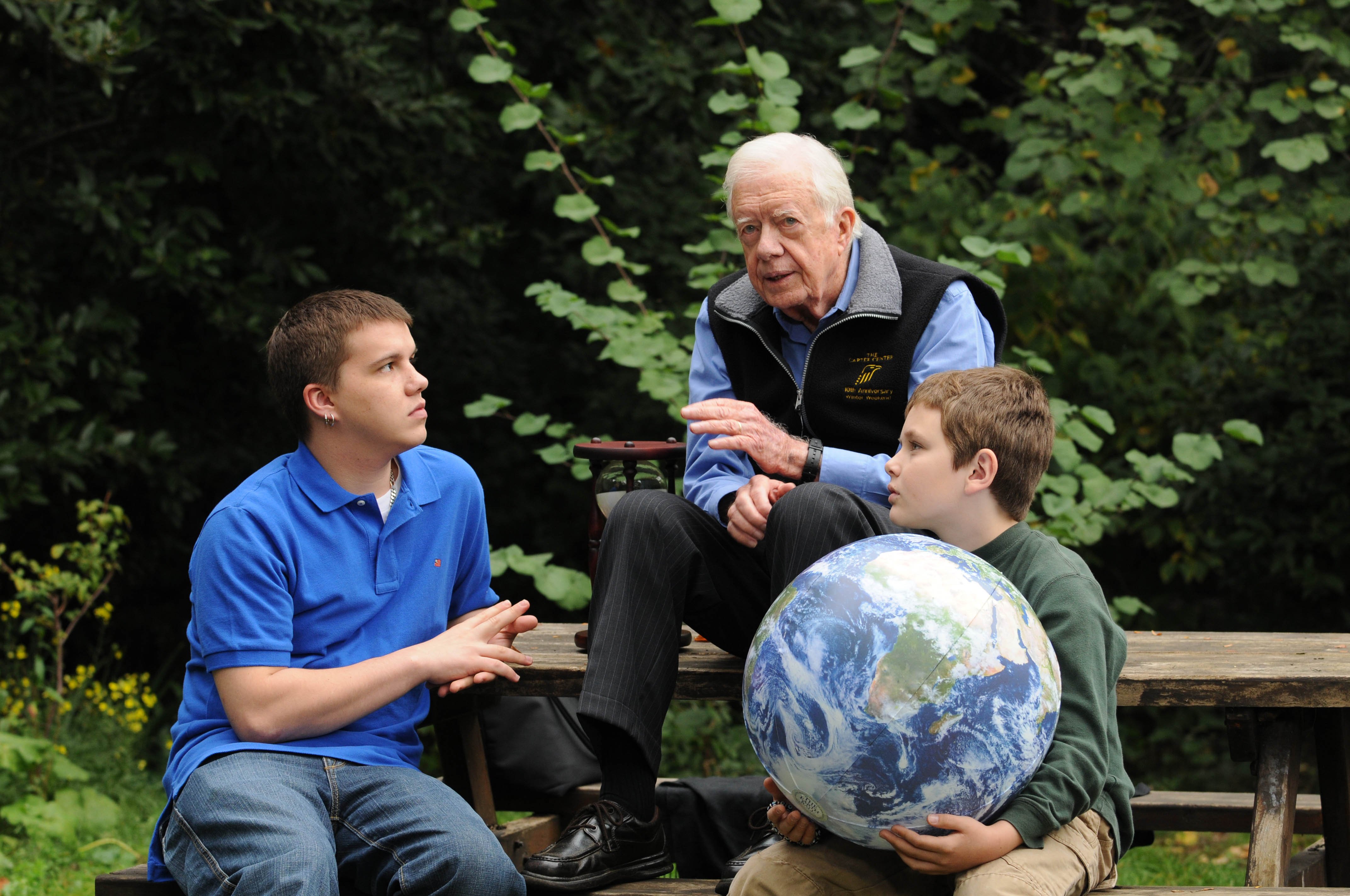 Jimmy Carter walks with his grandsons Jeremy Carter (R), 22, and Hugo Wentzel, 10 during a picnic event on October 31, 2009 in Istanbul, Turkey. | Source: Getty Images