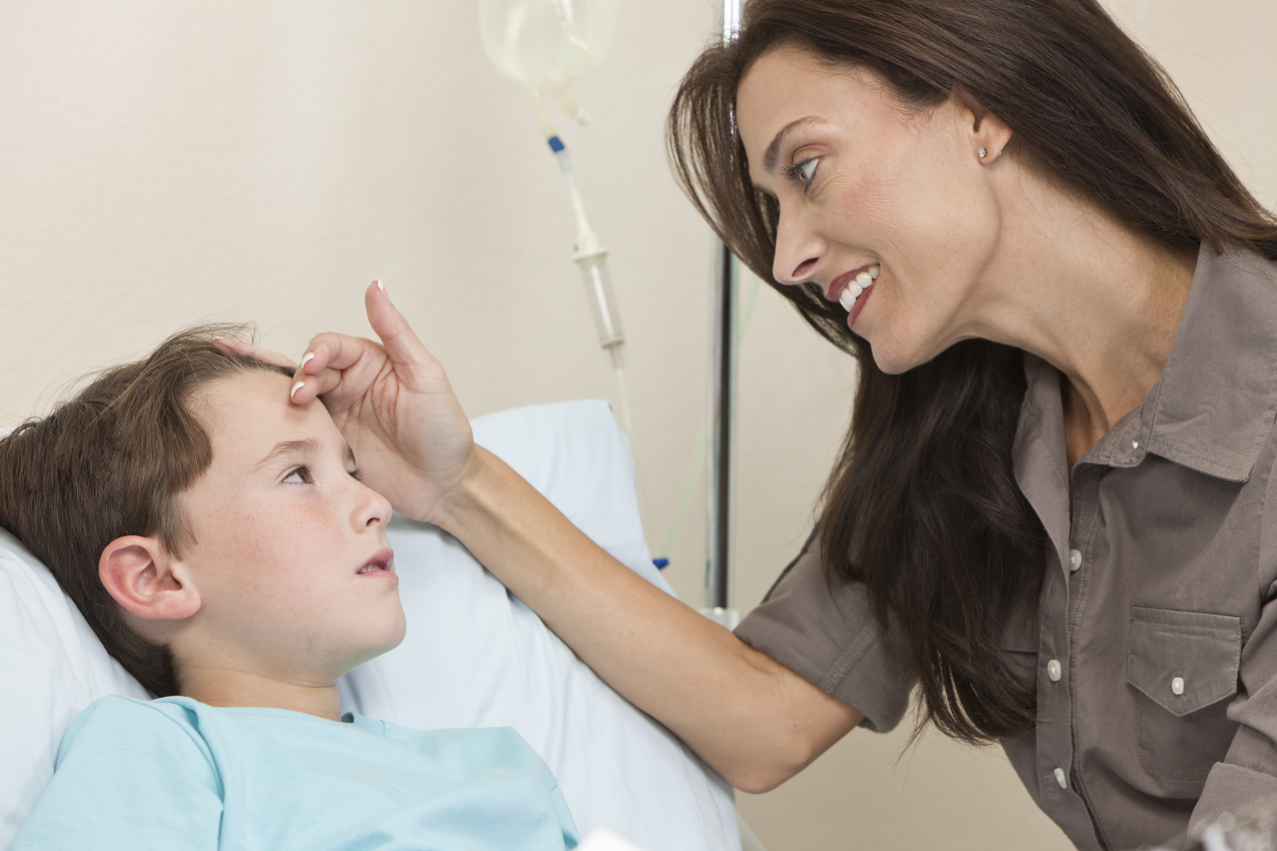 Mother visiting teen son in hospital ward | Source: Shutterstock.com