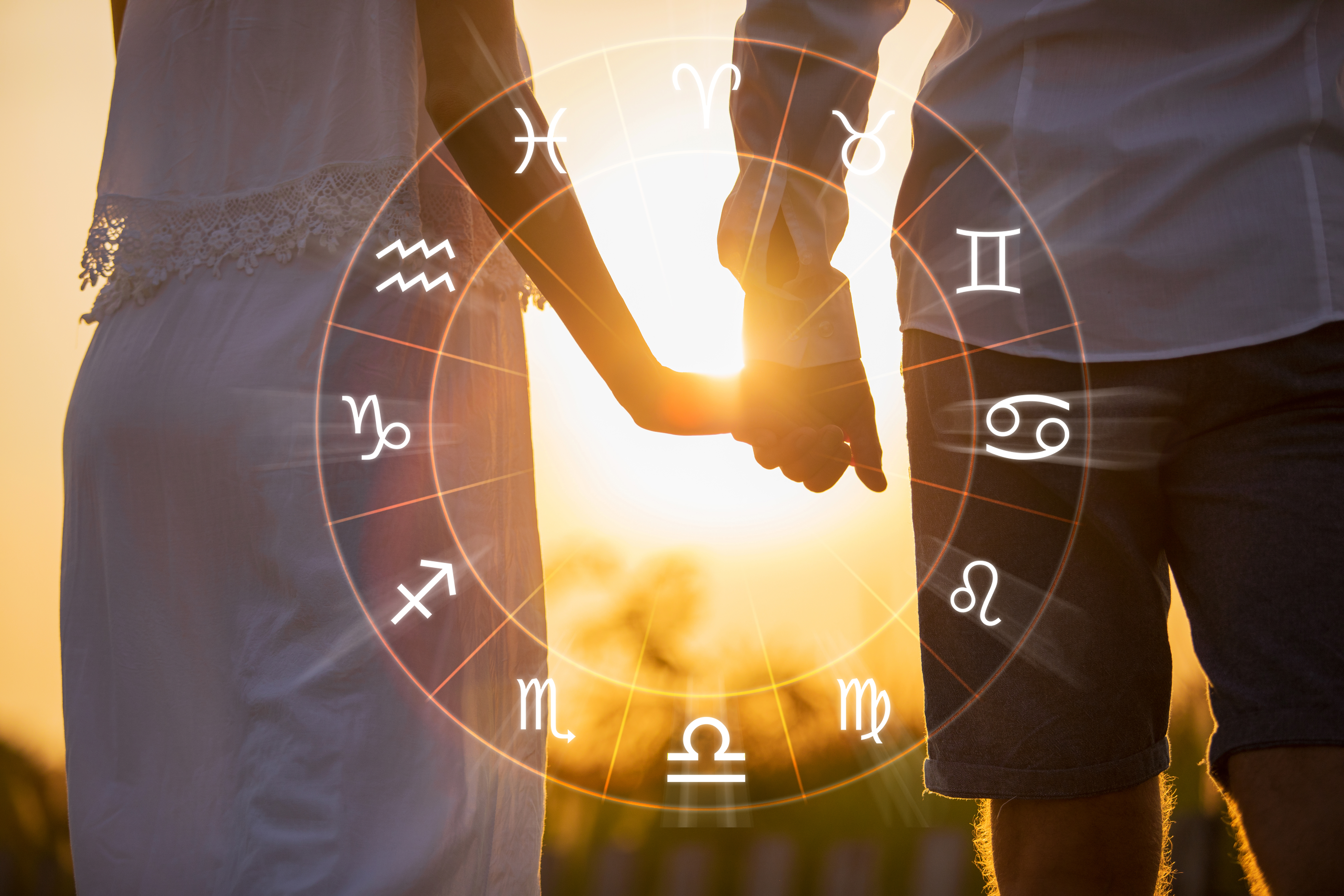 Couple holding hands inside the Zodiac wheel. | Source: Shutterstock