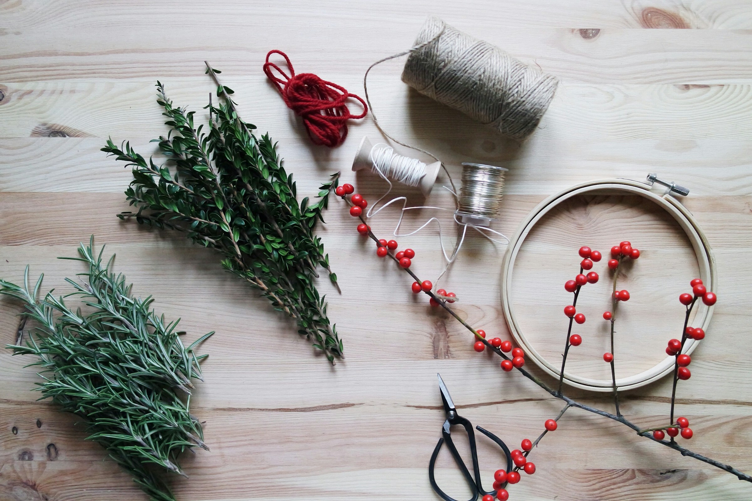 Herbs, string, scissors, and more on a table | Source: Unsplash