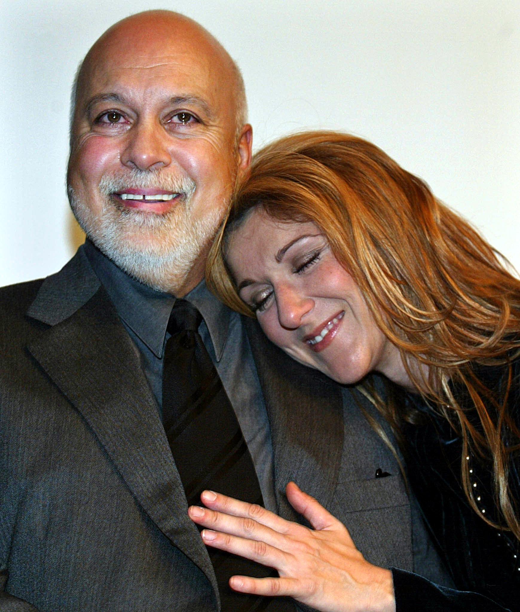 Rene Angelil and wife, Celine Dion, attend a news conference at Sainte-Justine Children's Hospital in Montreal, Canada, 18 December, 2002 | Source: Getty Images