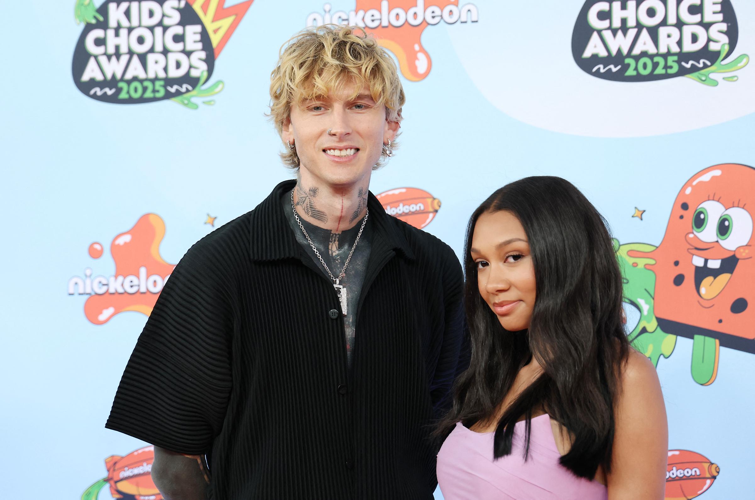 Machine Gun Kelly and his daughter Casie Baker pose side by side, smiling for the cameras at the 2025 Nickelodeon Kids' Choice Awards in Santa Monica on June 21.