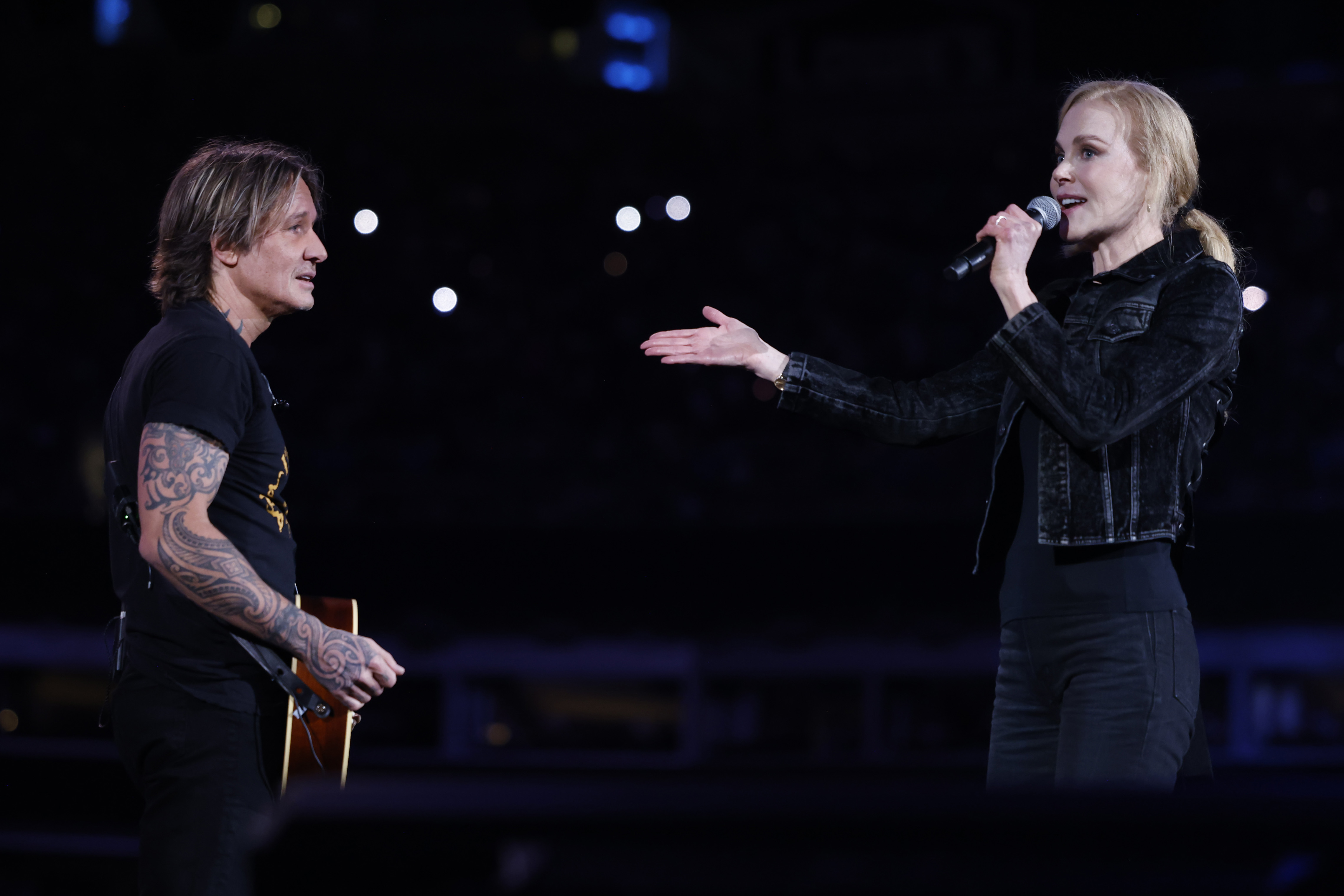 Keith Urban and Nicole Kidman speak onstage at the Benefit Concert held at Bank of America Stadium in Charlotte, North Carolina on October 26, 2024 | Source: Getty Images