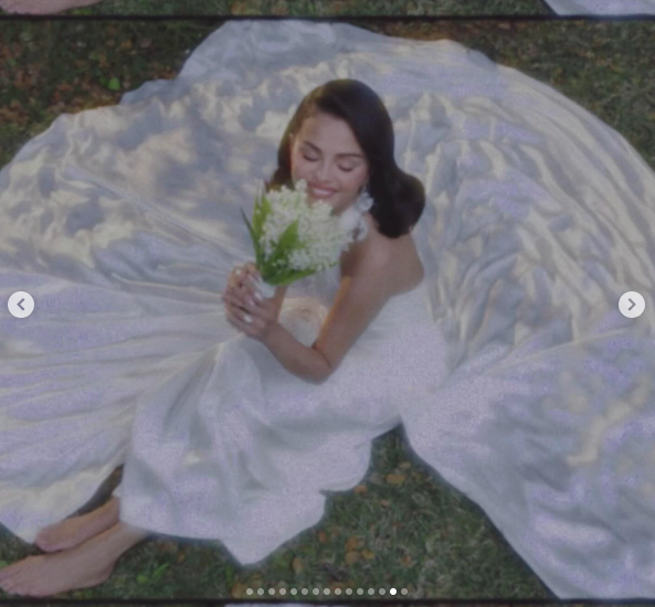 Selena Gomez posing in her wedding dress as she holds flowers. | Source: Instagram/selenagomez