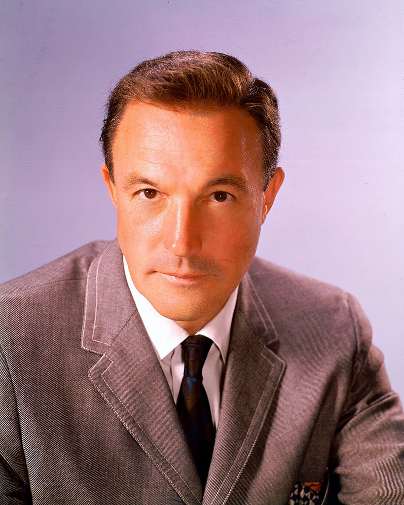 Studio portrait of Gene Kelly wearing a grey jacket, white shirt and dark tie, circa 1950. | Photo: Getty Images