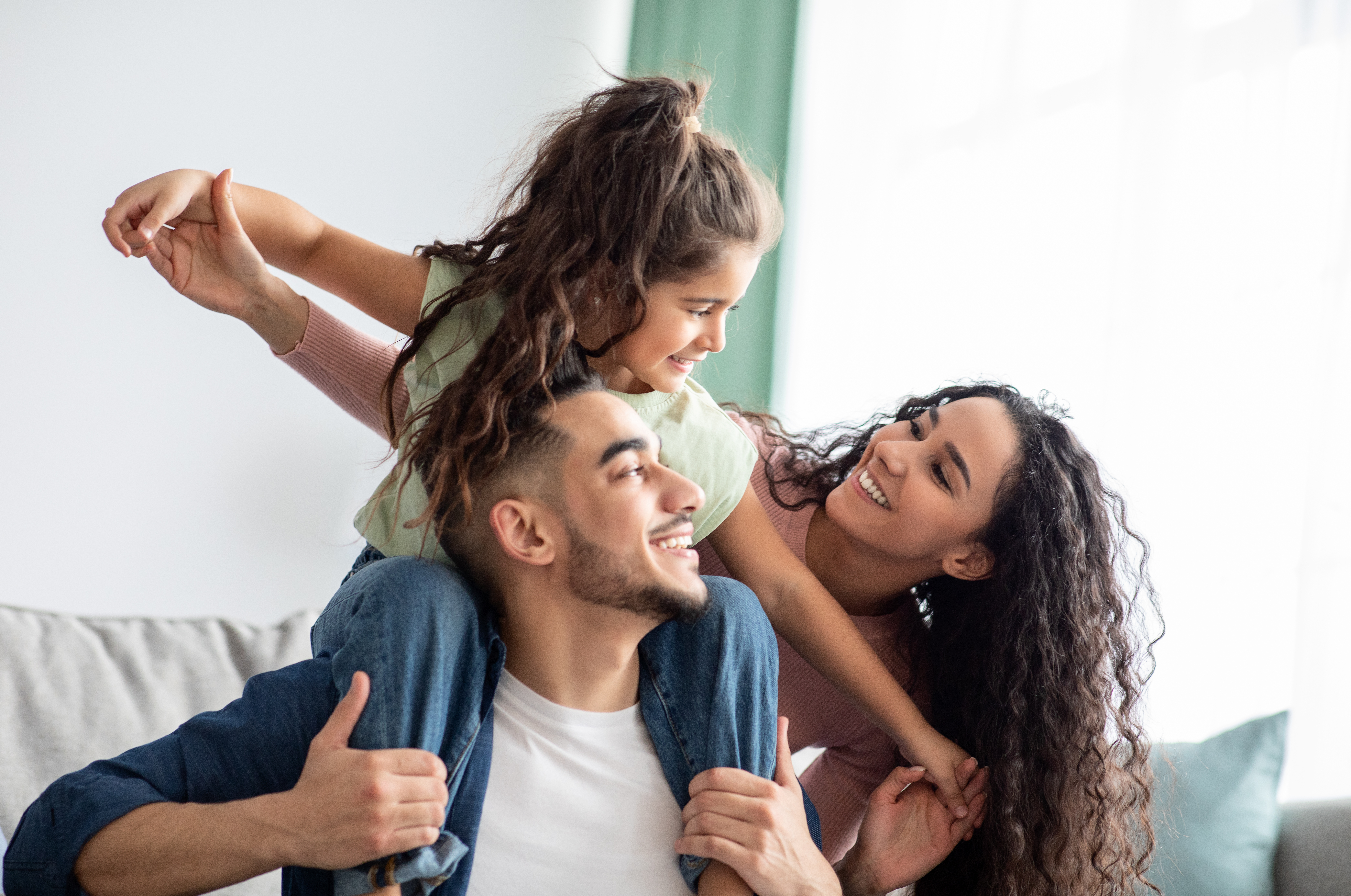 Parents are playing with their daughter | Source: Shutterstock