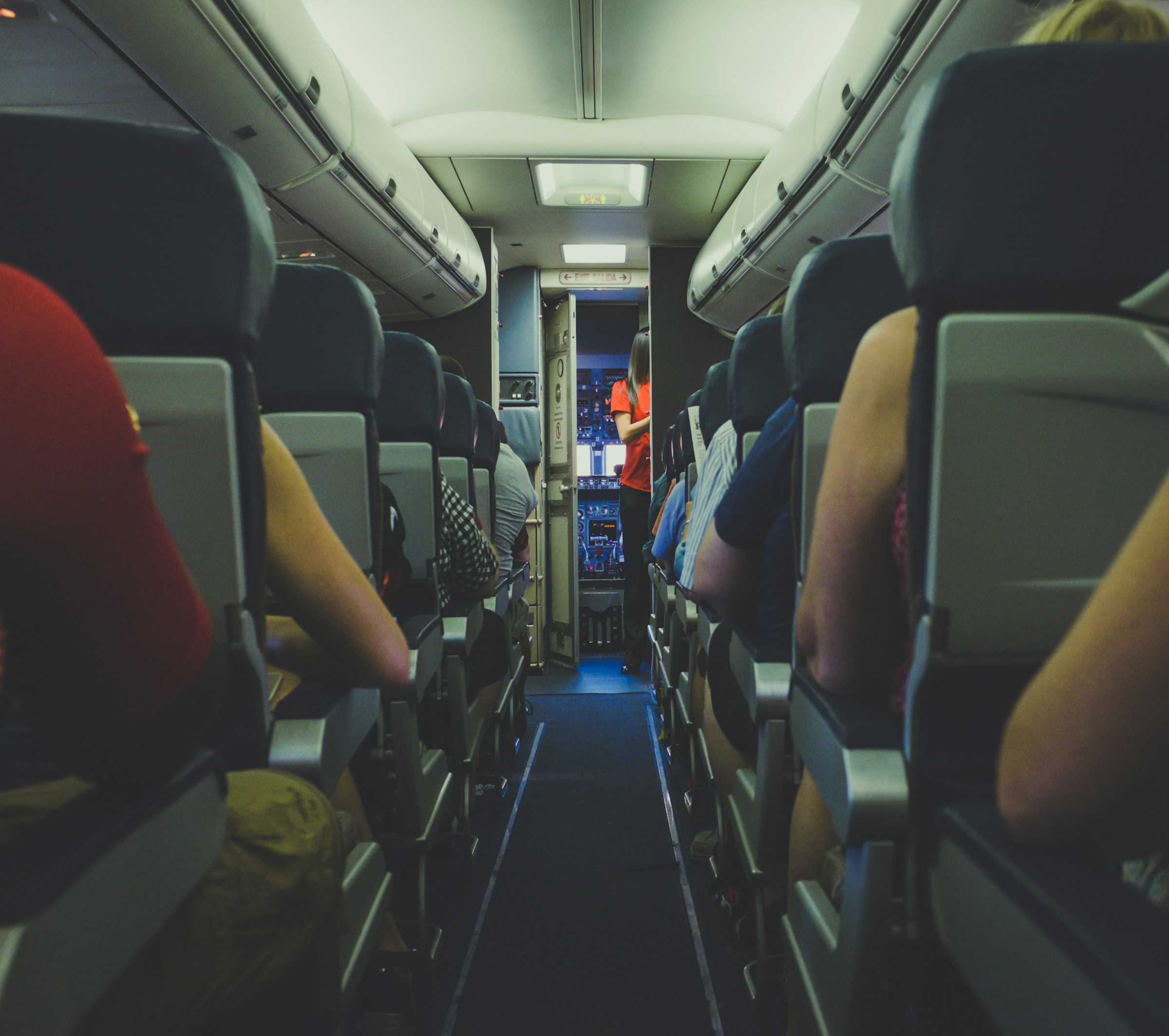 A stewardess and people in an airplane | Source: Unsplash