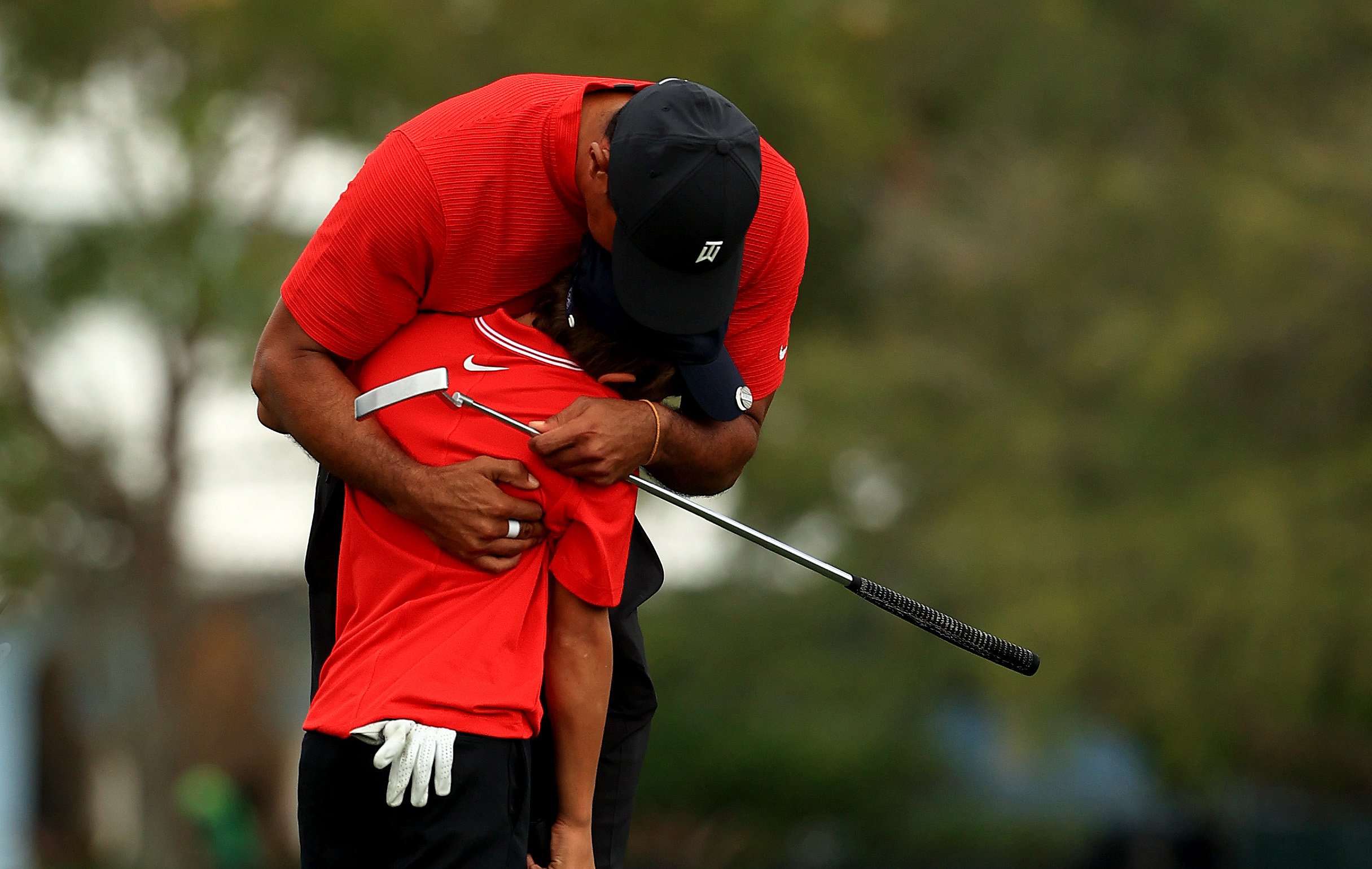 Tiger Woods of the United States and son Charlie Woods hug at the Ritz Carlton Golf Club on December 20, 2020 in Orlando, Florida. | Source: Getty Images