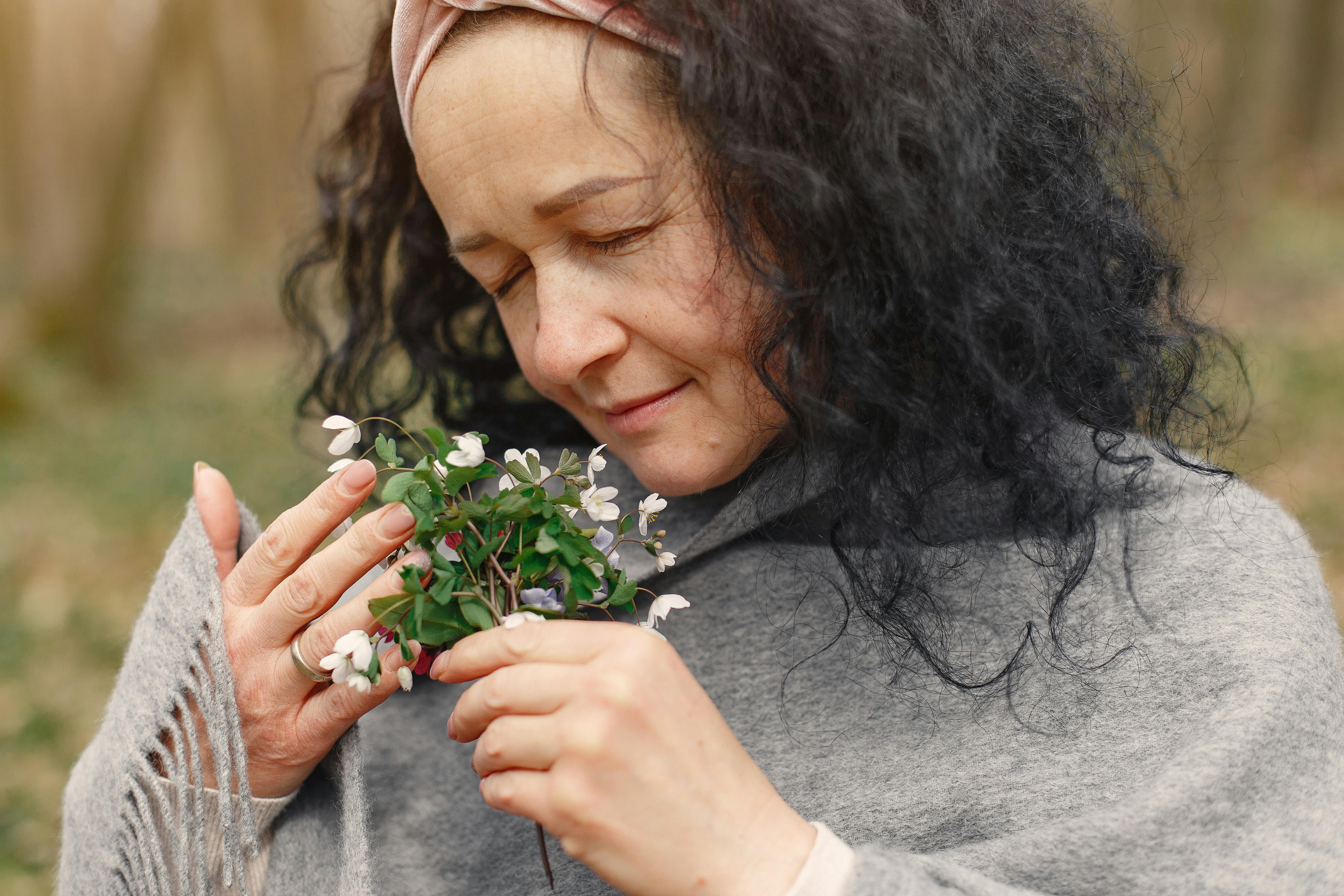 A woman smelling flowers | Source: Pexels