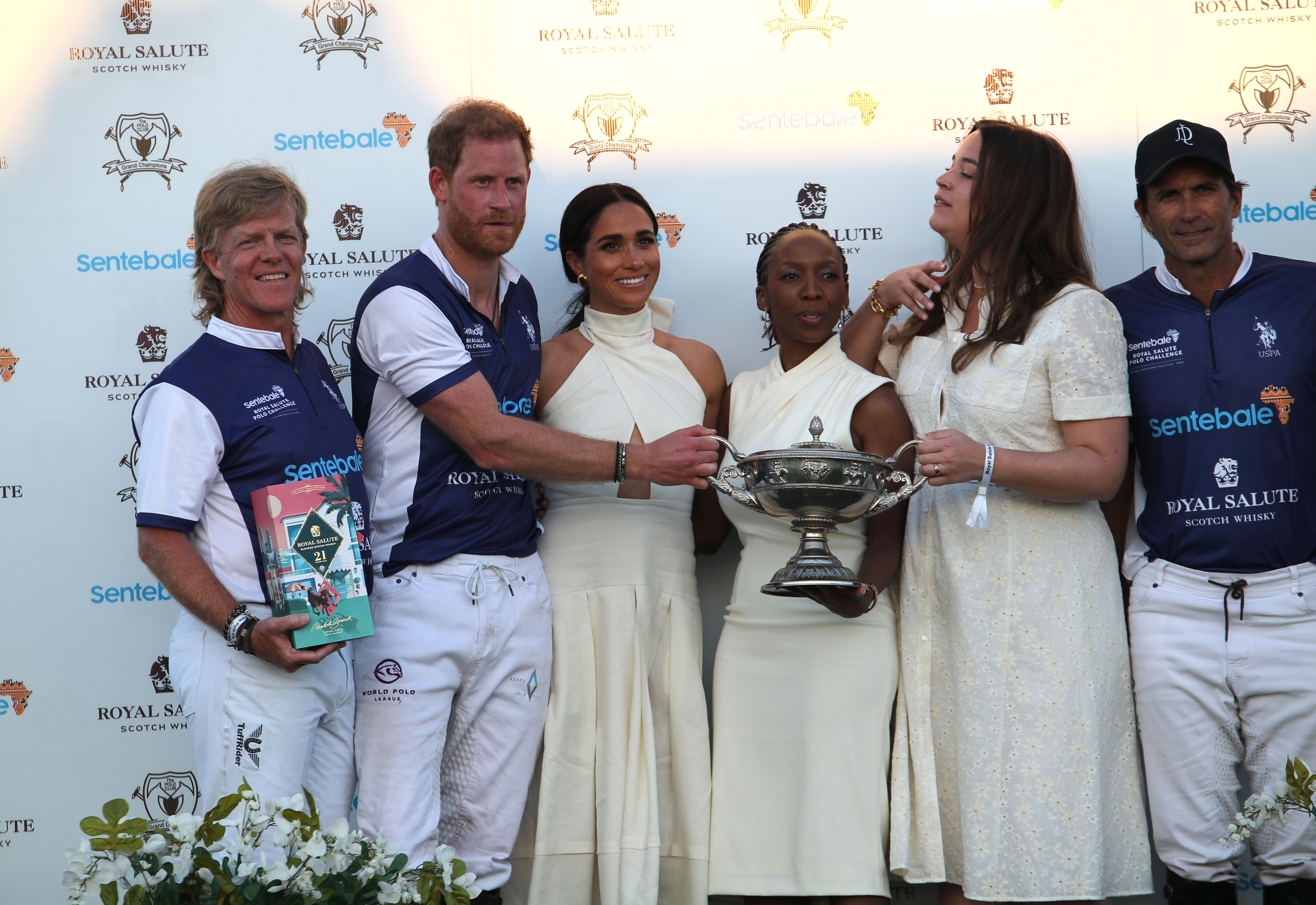 Meghan Markle, Duchess of Sussex presents the trophy to Prince Harry, The Duke of Sussex after his team wins, in the Royal Salute Polo Challenge, to benefit Sentebale, in Wellington, Florida, on April 12, 2024. | Source: Getty Images