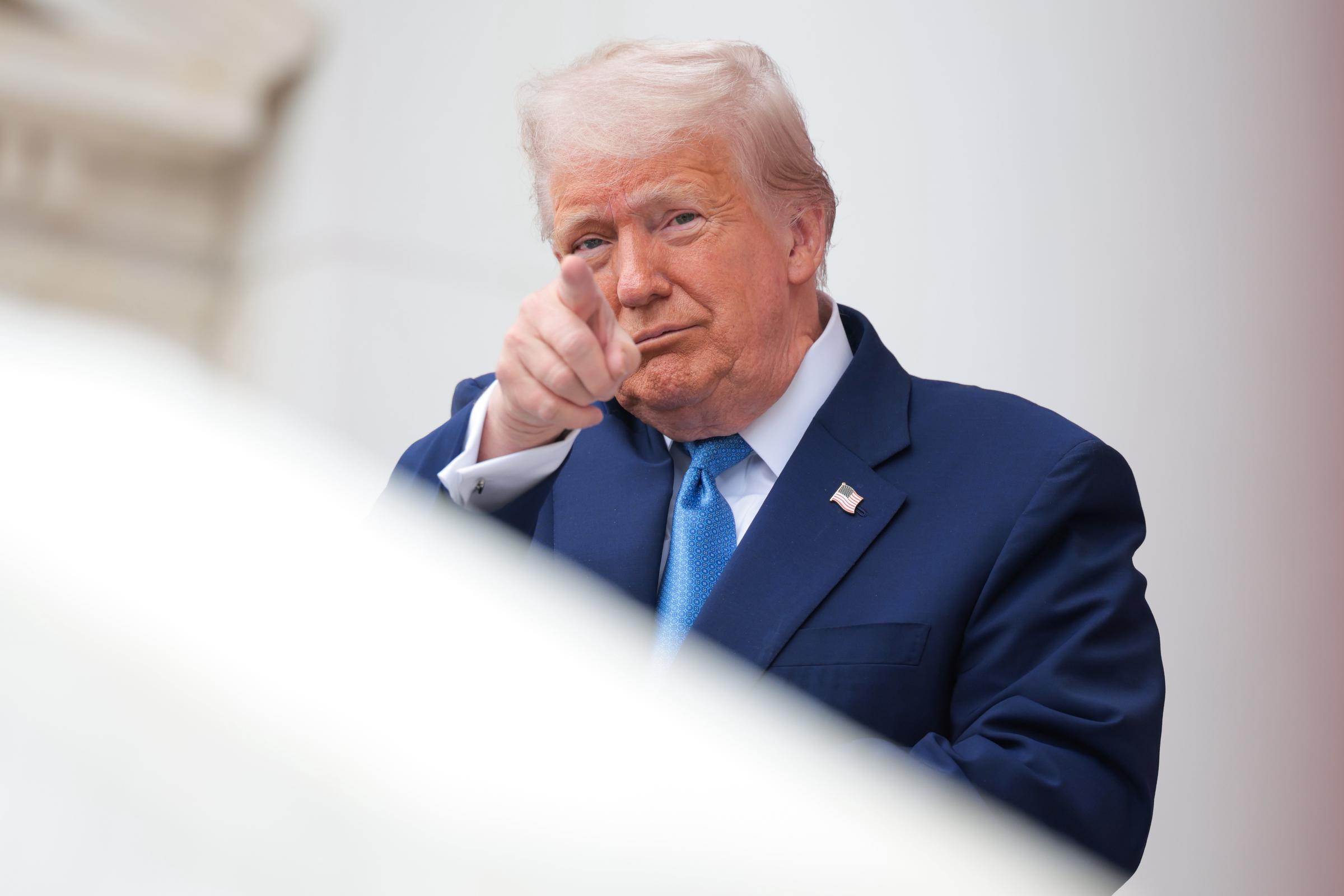 President Donald Trump is pictured pointing his finger during his presence at the Memorial Day wreath-laying ceremony on May 26, 2025, in Arlington, Virginia | Source: Getty Images