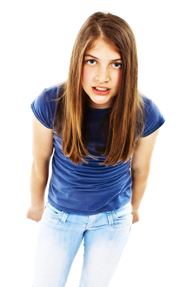 Angry teenager being rude to an adult. | Photo: Shutterstock.