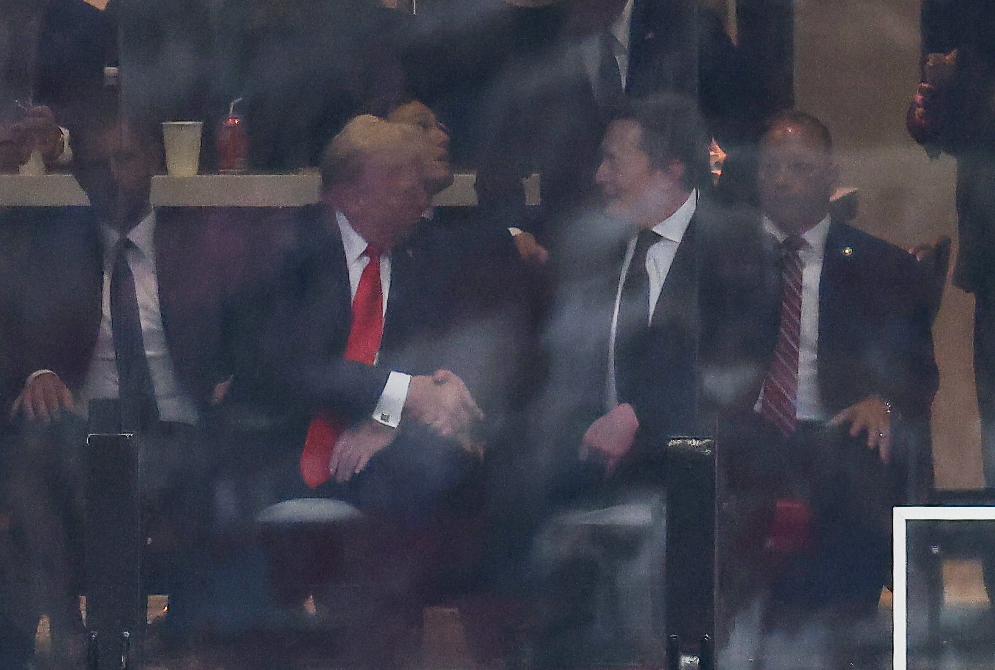 President Donald Trump and Tesla CEO Elon Musk shake hands during the public memorial service for right-wing activist Charlie Kirk at State Farm Stadium on September 21, 2025, in Glendale, Arizona. | Source: Getty Images