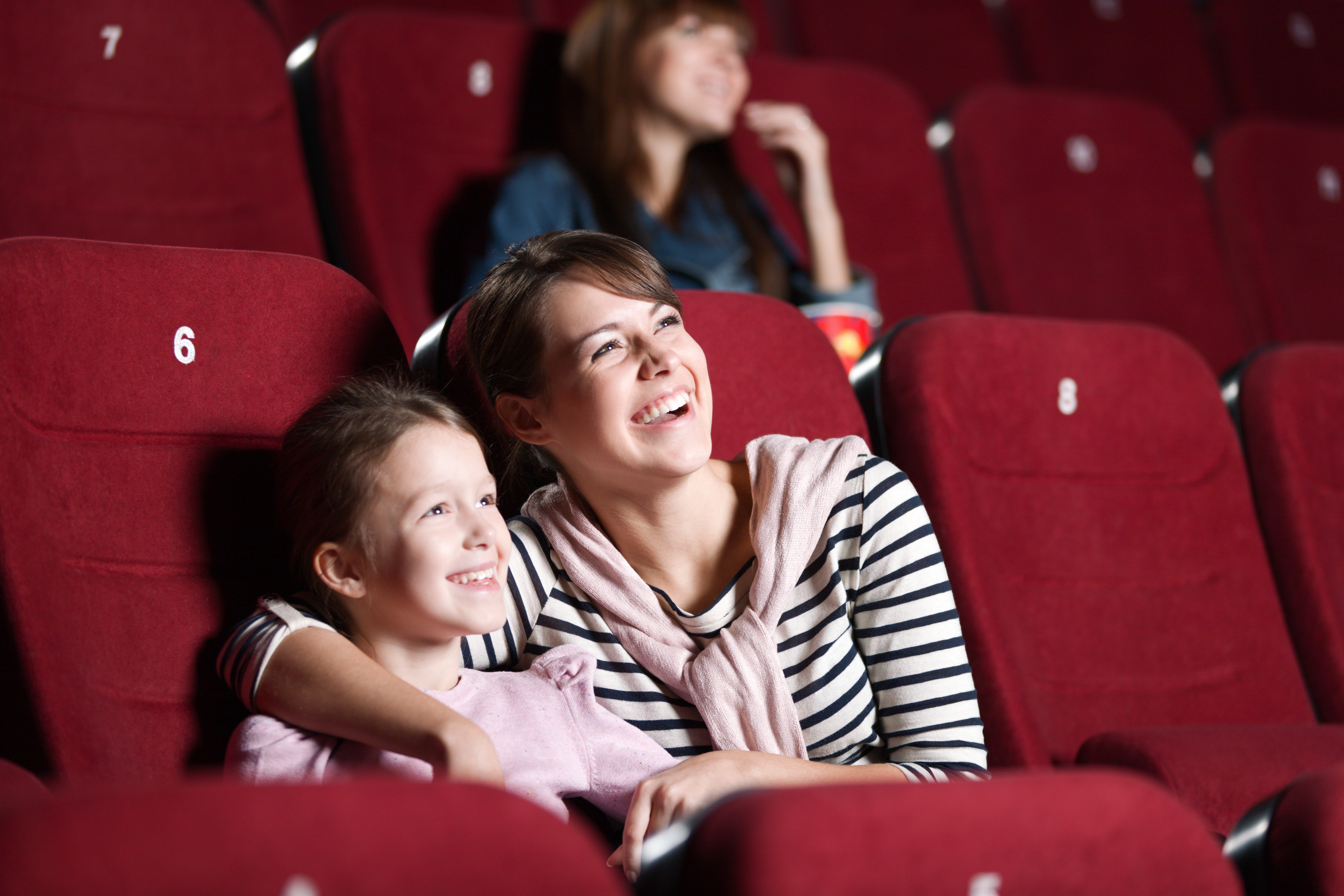 A mother watching a movie with her little daughter | Source: Shutterstock