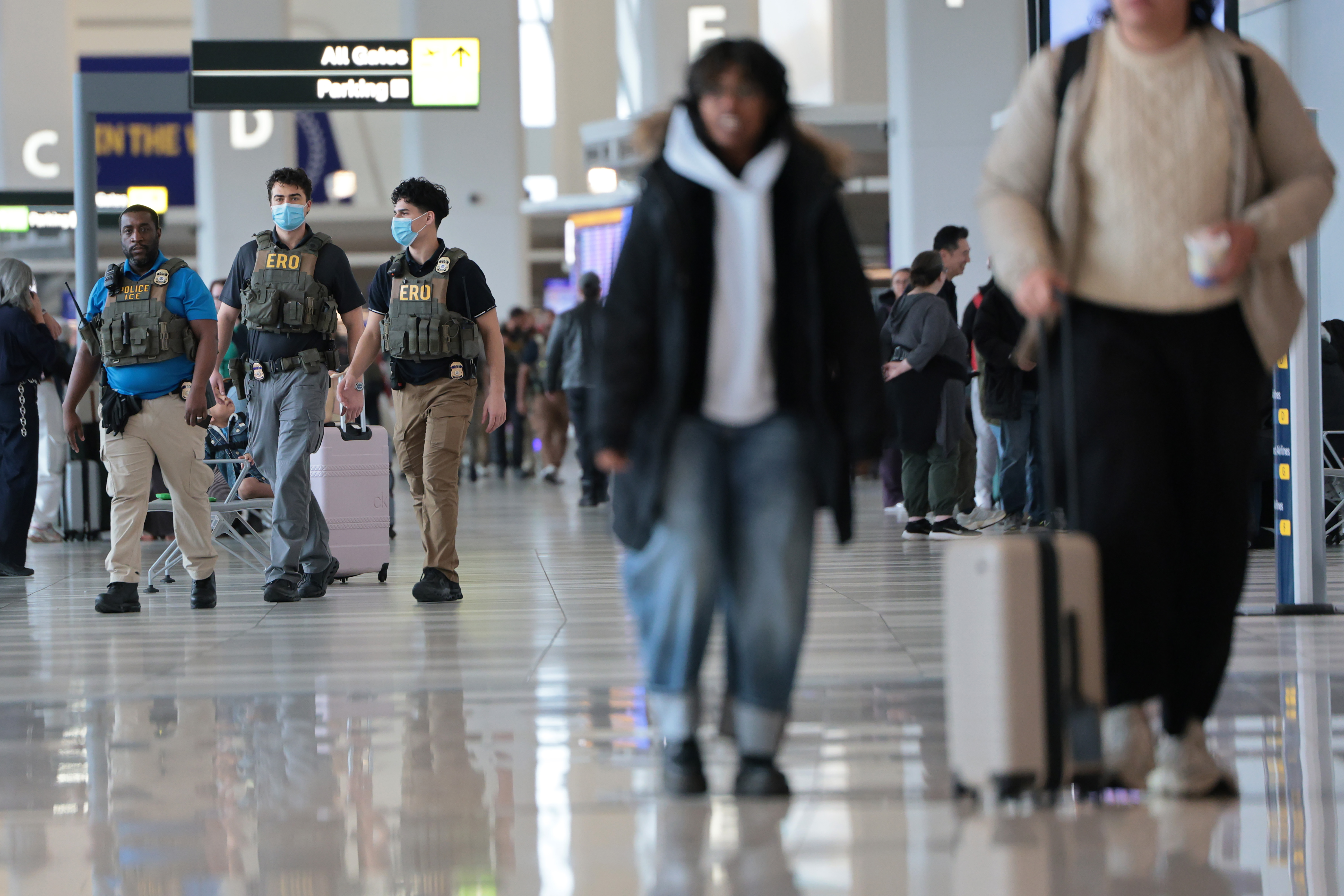 ICE agents walking inside LaGuardia Airport terminal following the crash in New York City, March 23, 2026 | Source: Getty Images