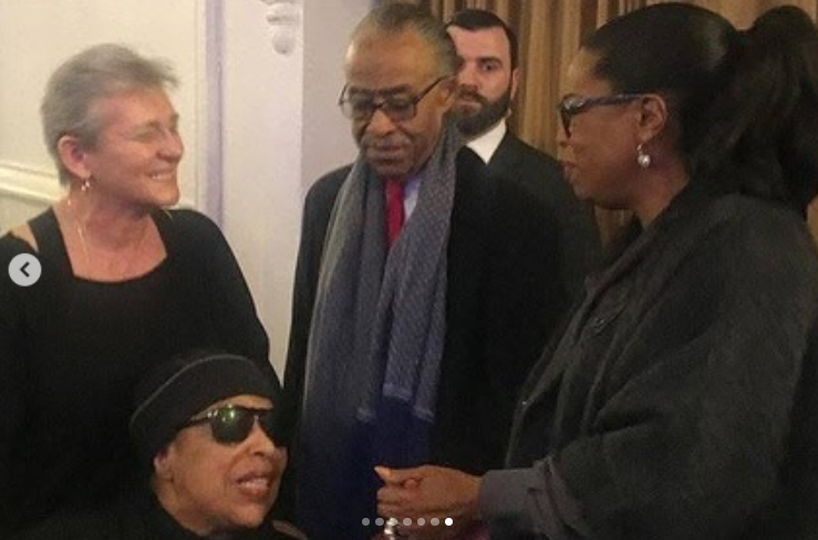 Roberta Flack, wearing sunglasses and a black headscarf, shares a moment with Al Sharpton and others at a public event, posted on February 24, 2025 | Source: Instagram/real_sharpton