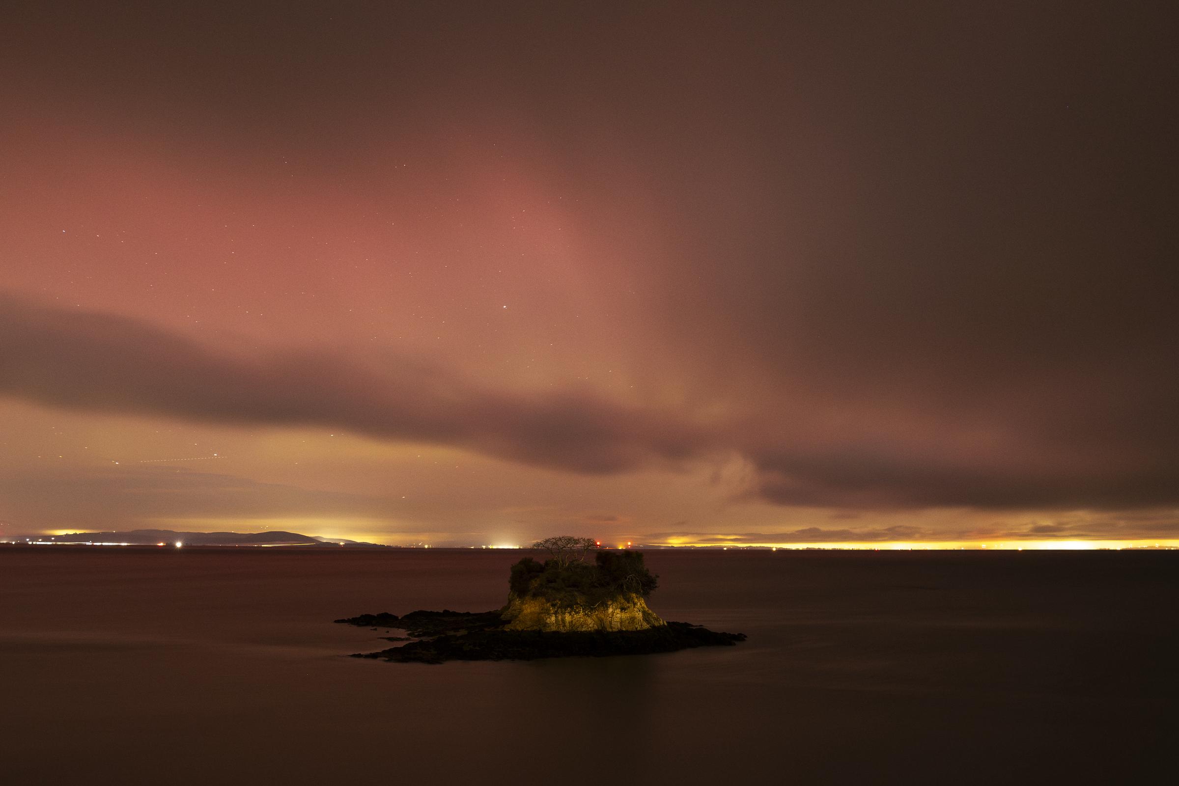 Rat Rock Island is seen at China Camp State Park as the Northern Lights glow above rolling fog in San Rafael, California, on November 11, 2025 | Source: Getty Images