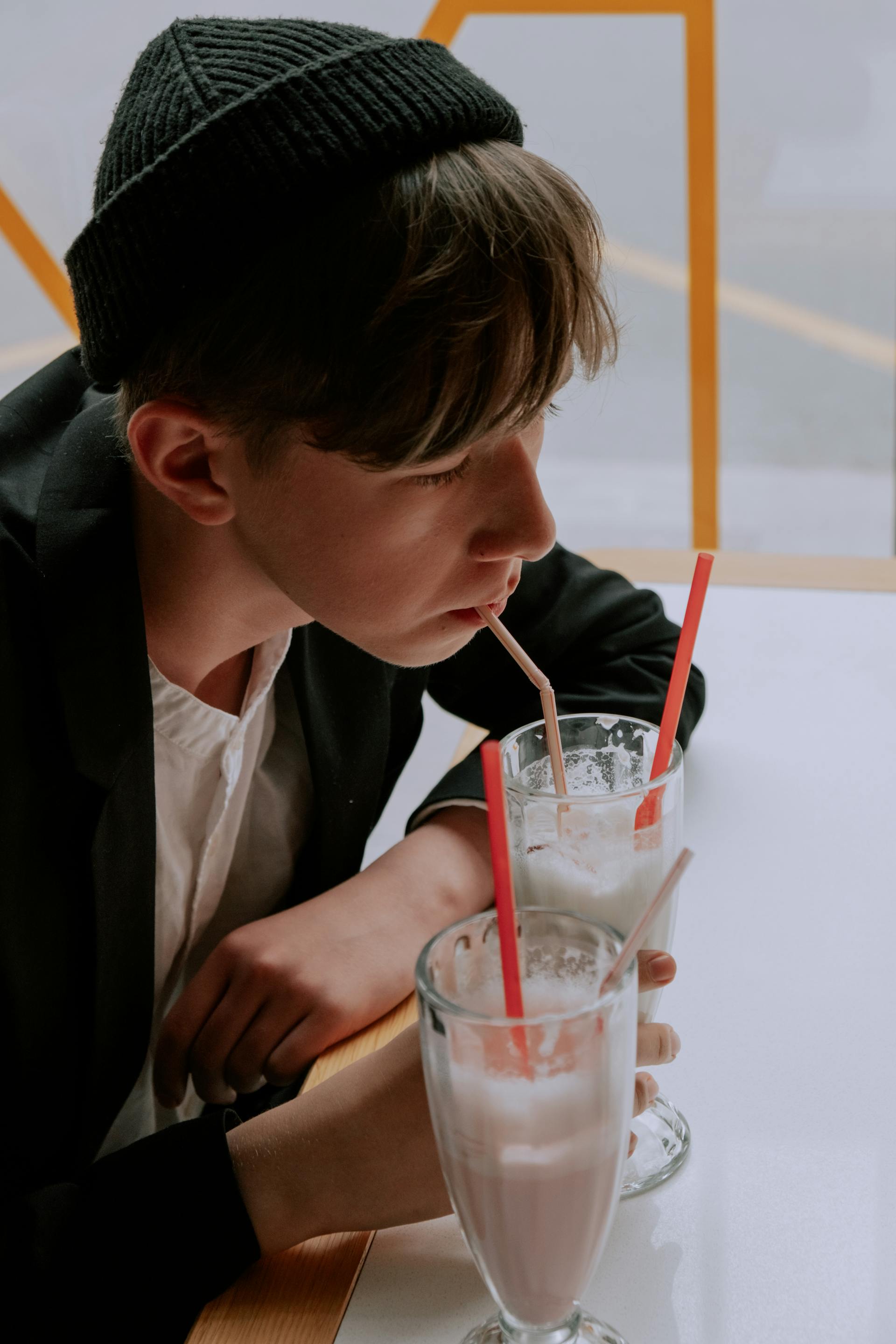 A boy drinking a milkshake | Source: Pexels