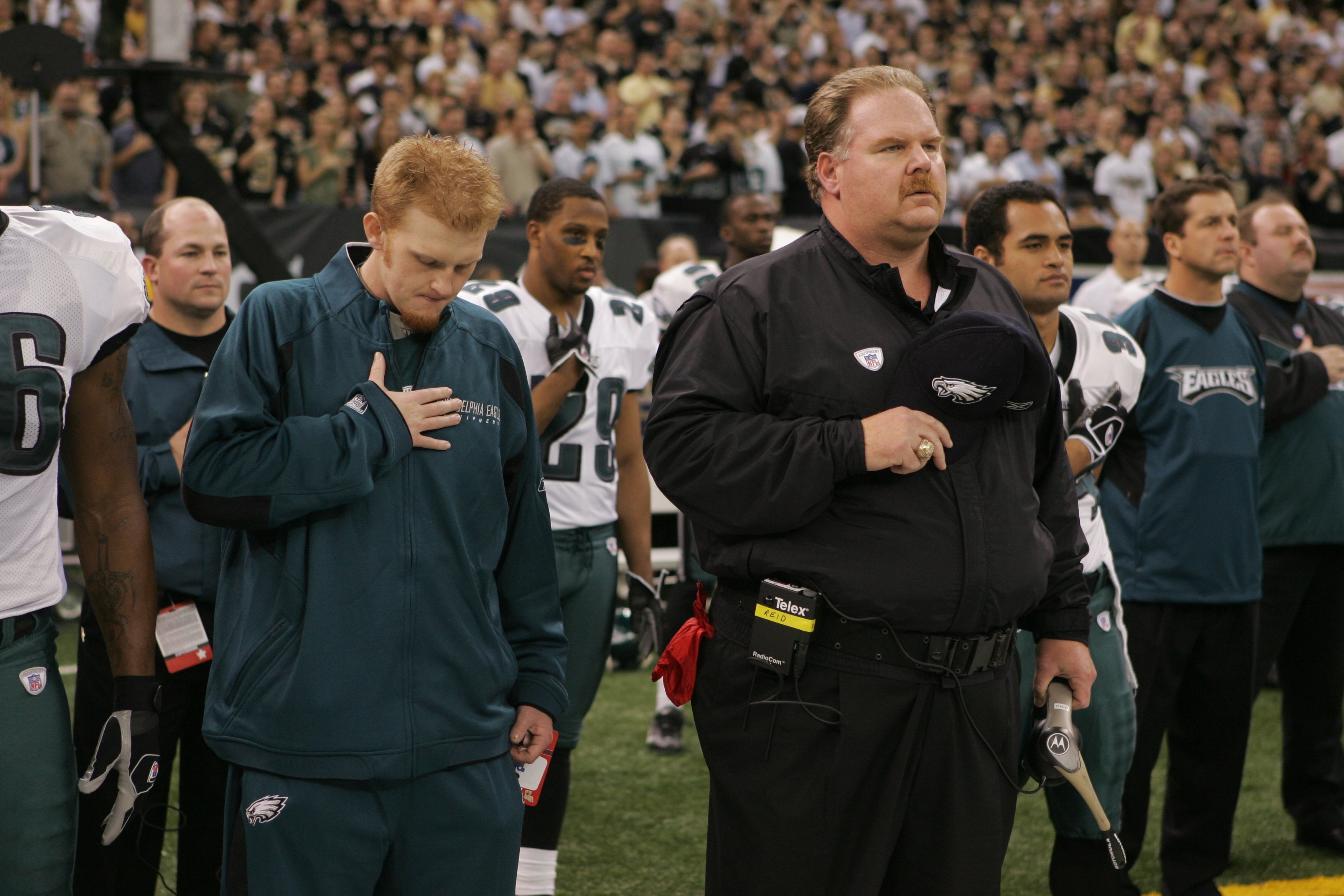 Father and son, Andy and Britt Reid during the national anthem at the Philadelphia Eagles vs New Orleans Saints game, January, 2007. | Photo: Getty Images. 