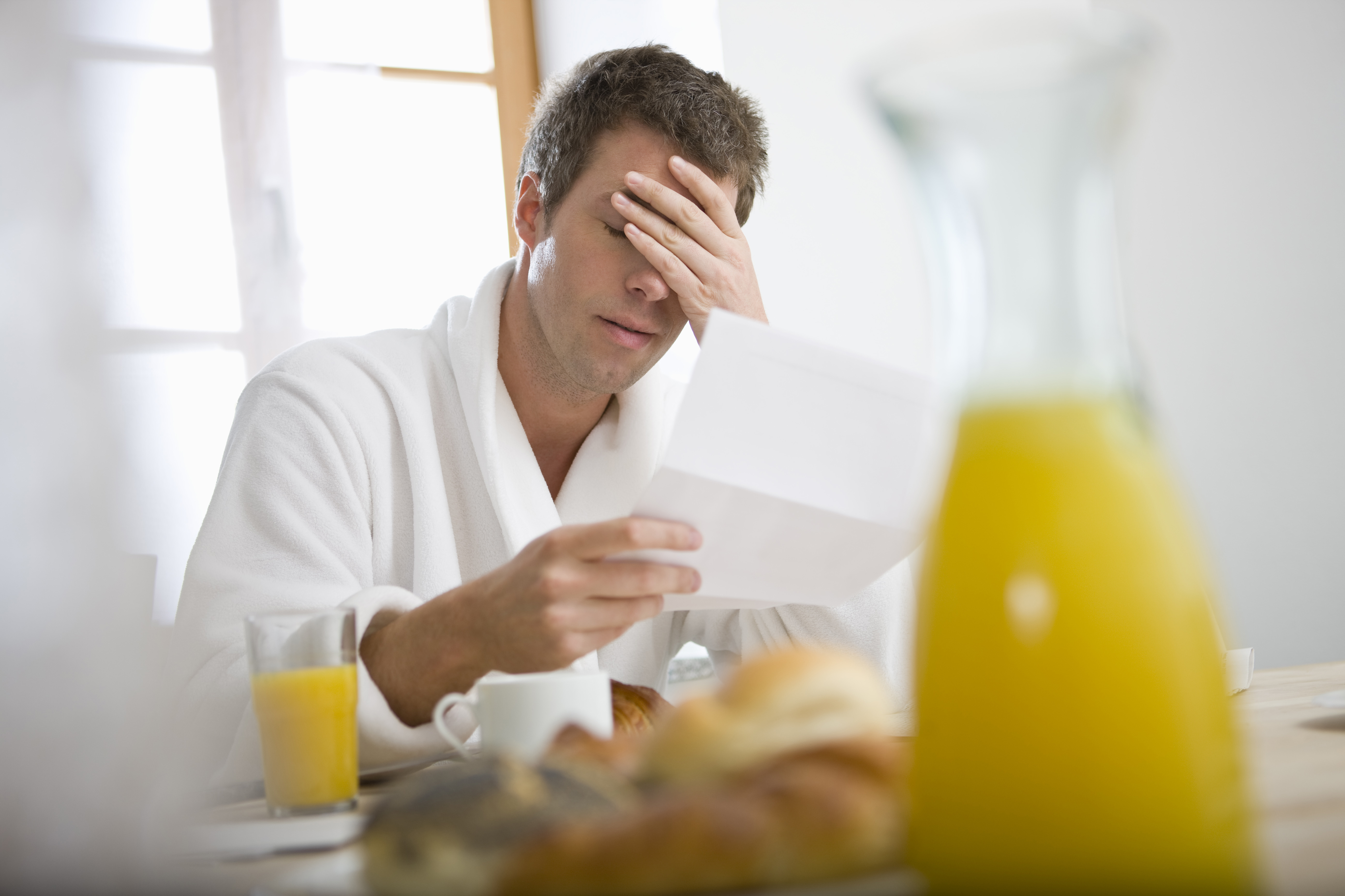 An unhappy man reading a letter | Source: Getty Images