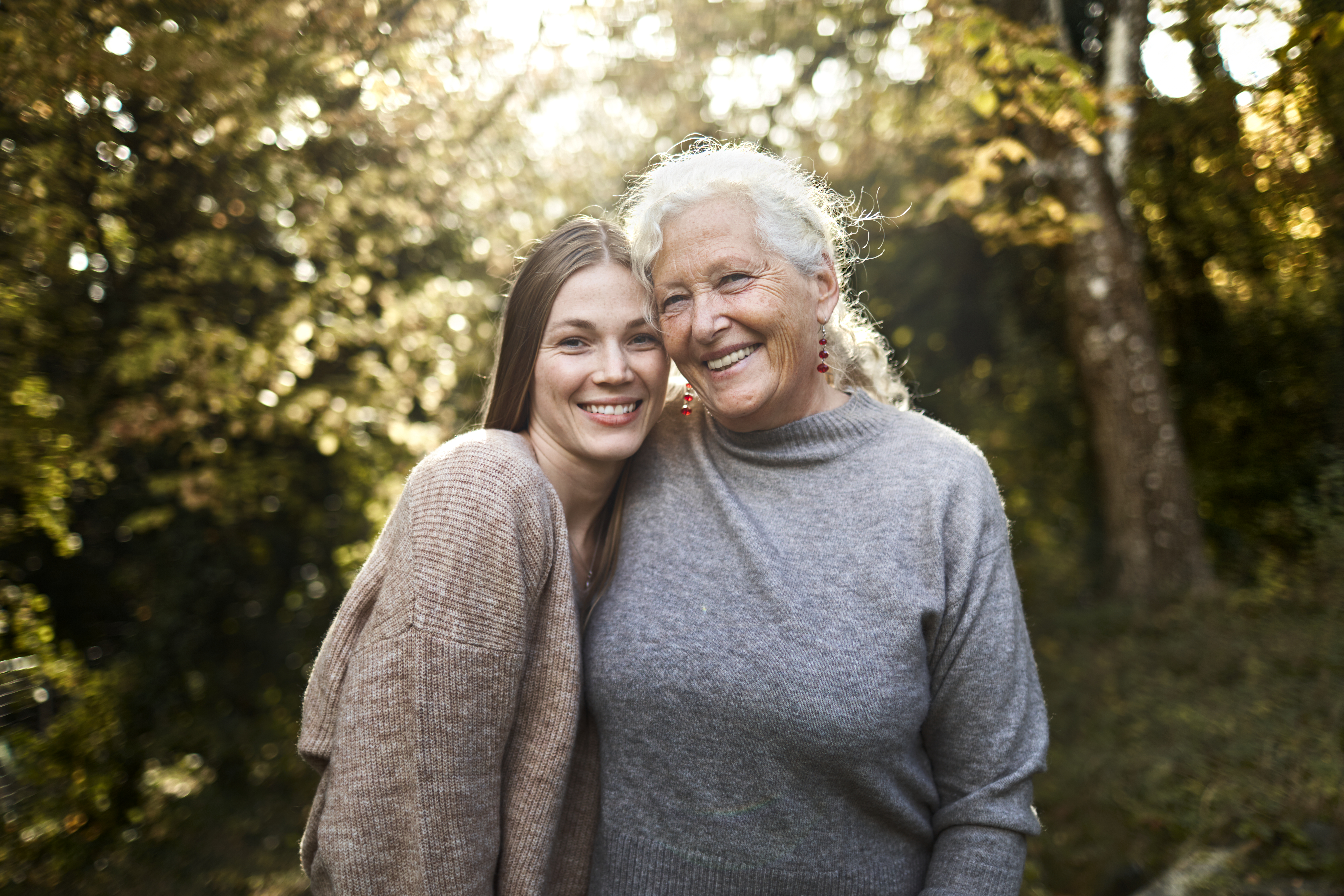 Portrait of happy grandmother and adult granddaughter in garden | Source: Getty Images