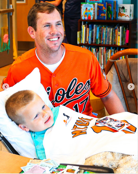 Brian Matusz poses with a young fans, from a post dated January 8, 2025 | Source: Instagram/orioles