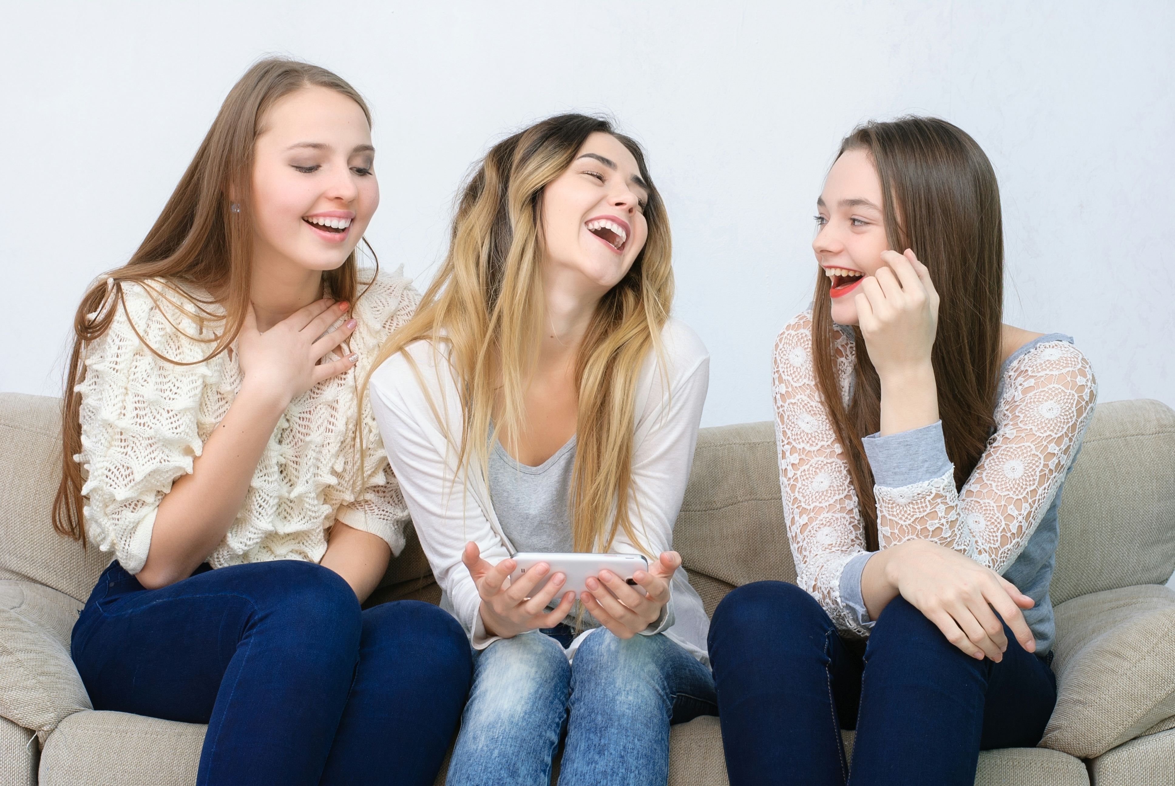 Three teenage girls laughing | Source: Shutterstock