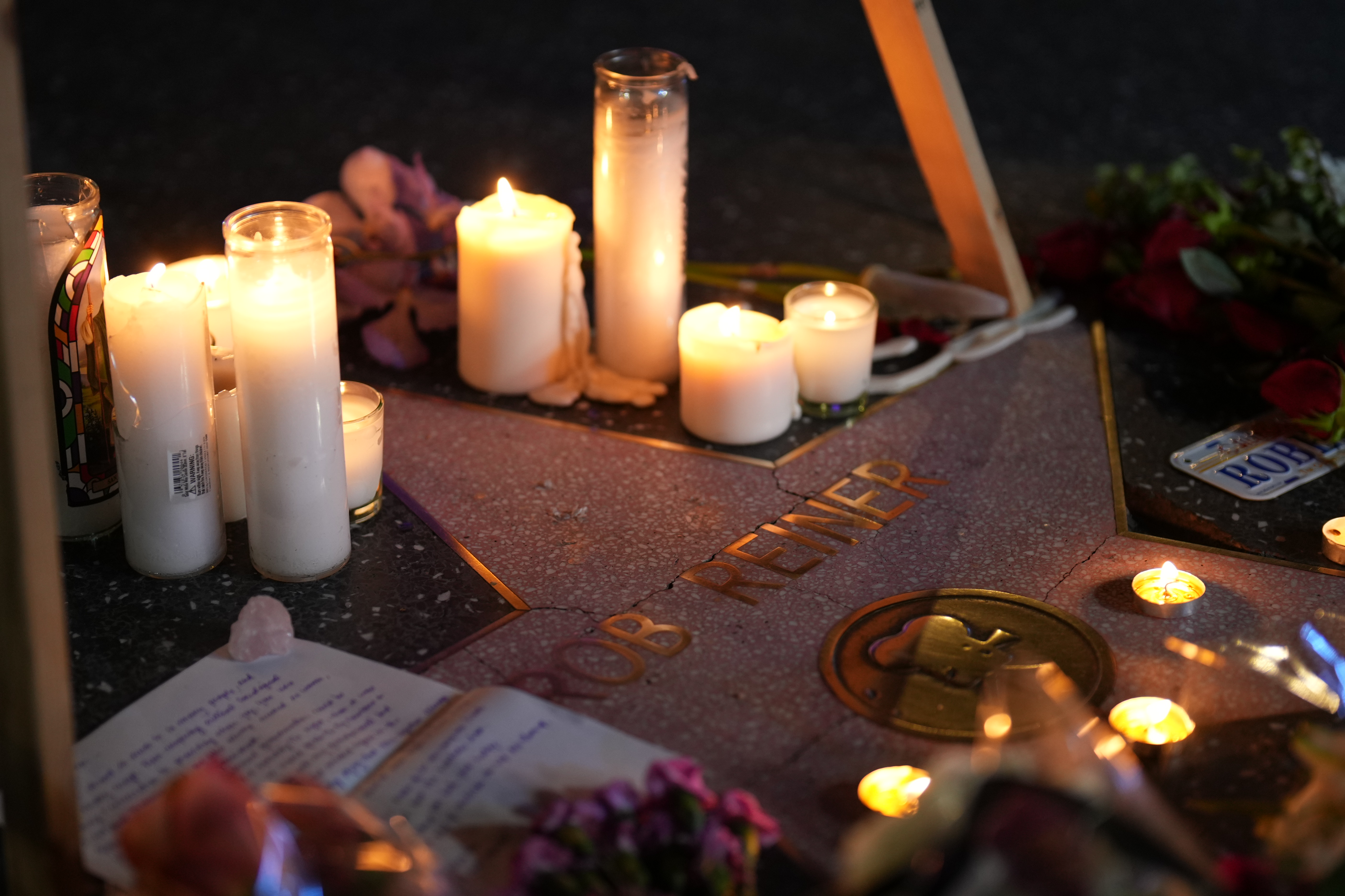 Flowers and candles at Rob Reiner's Hollywood Walk of Fame star in Los Angeles on December 15, 2025 | Source: Getty Images