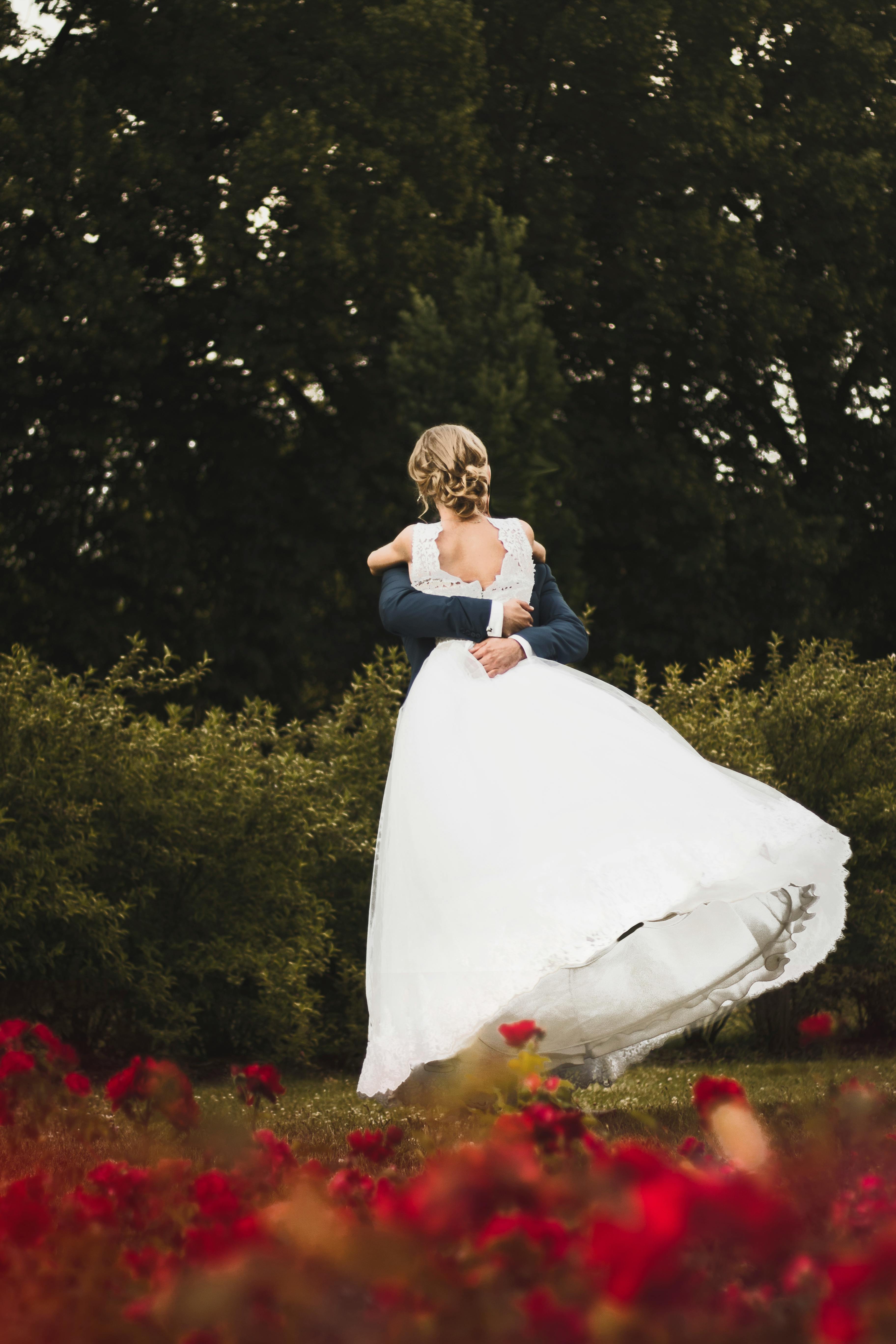 A bride embracing a man on her wedding day | Source: Pexels