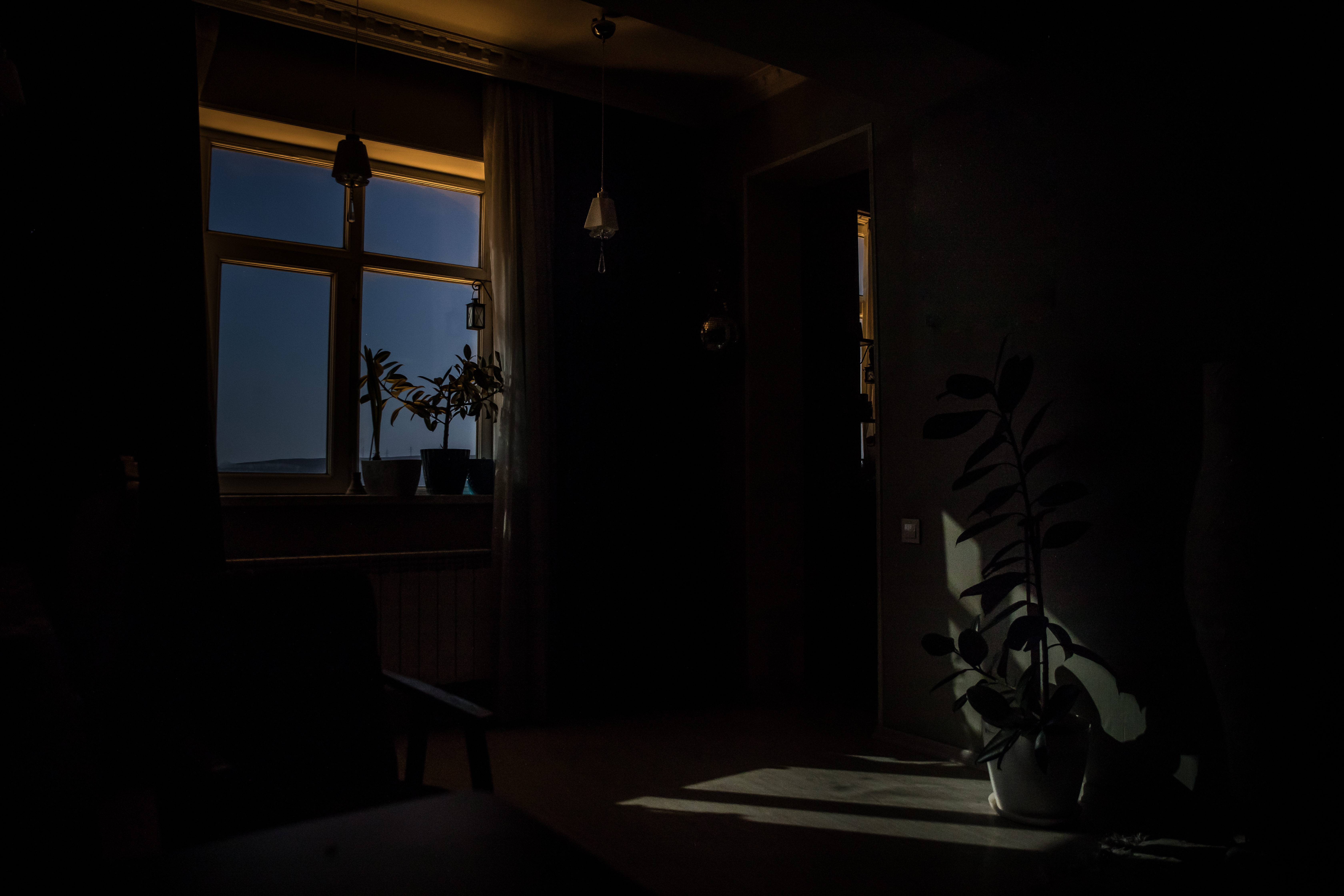 Night scene of moon seen through the window from dark room | Source: Shutterstock.com
