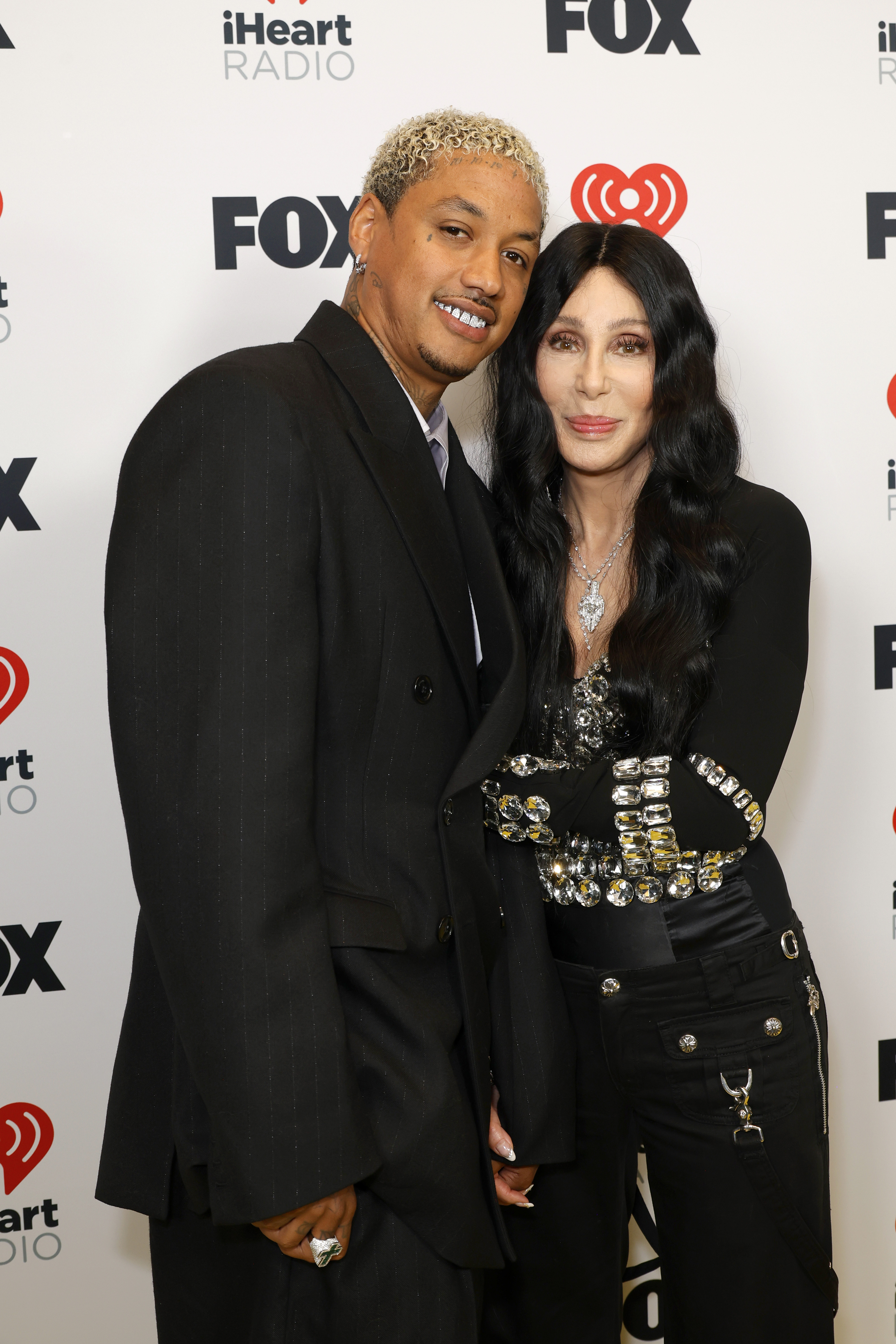 Alexander "AE" Edwards and Cher pose together at the 2024 iHeartRadio Music Awards on April 1, 2024, in Hollywood, California. | Source: Getty Images