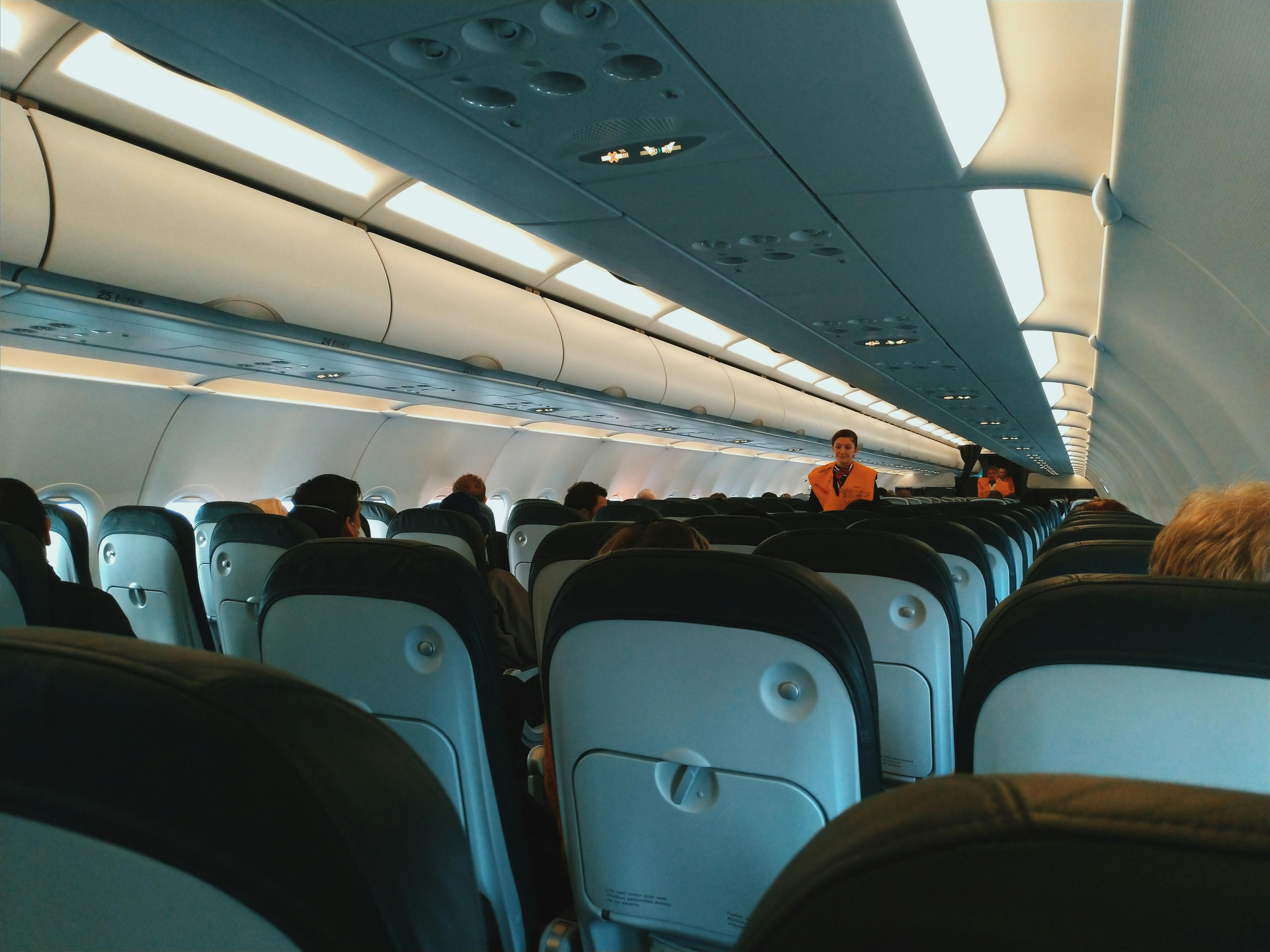 A flight attendant walking on a plane | Source: Pexels