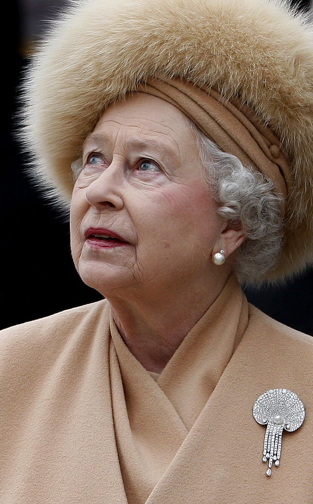 Queen Elizabeth II looks up at the statue of her mother as she attends the unveiling of a new statue of Queen Elizabeth, the Queen Mother on the Mall on February 24, 2009 in London, England | Photo: Getty Images