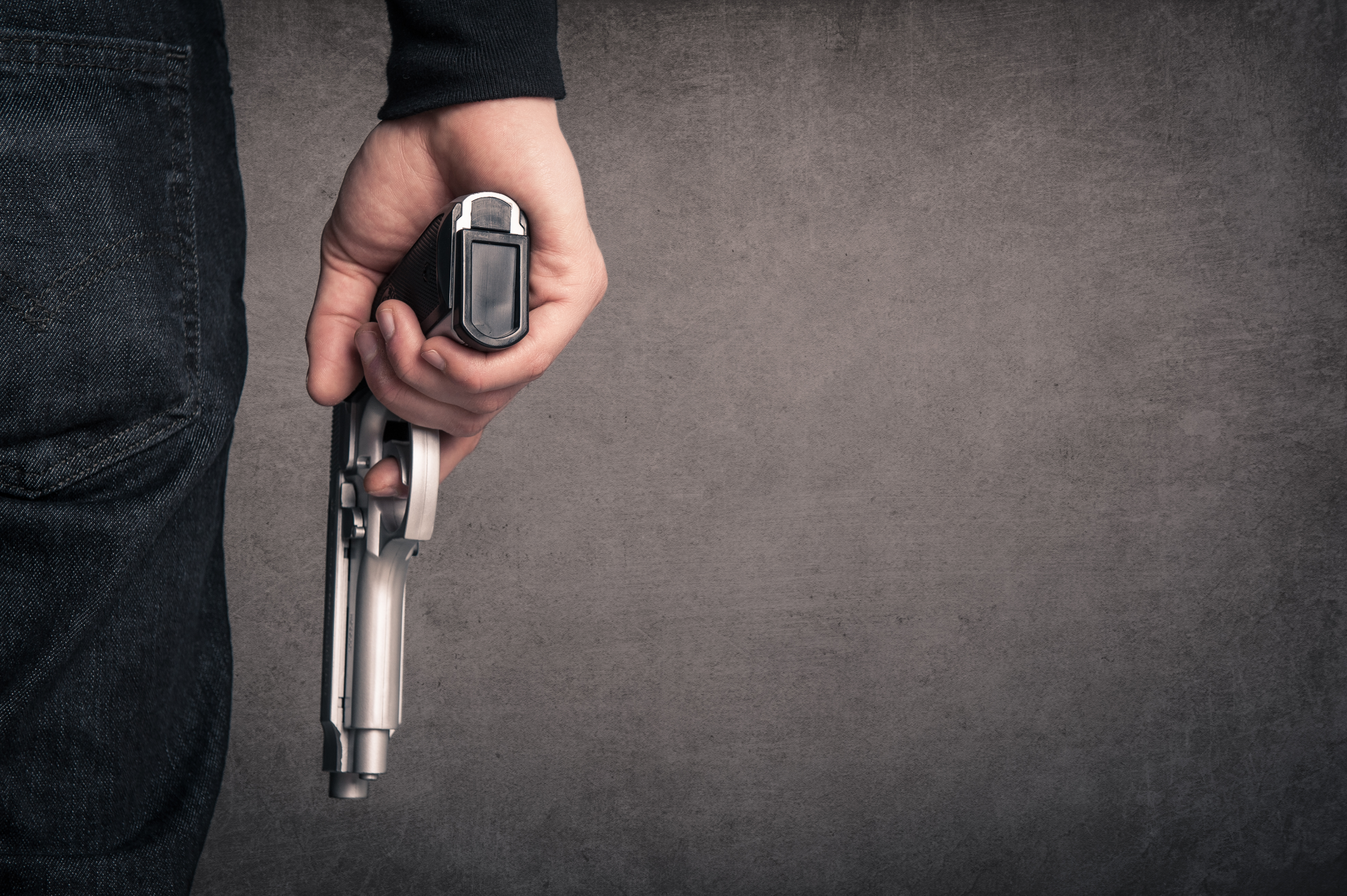 Killer with gun | Source: Shutterstock