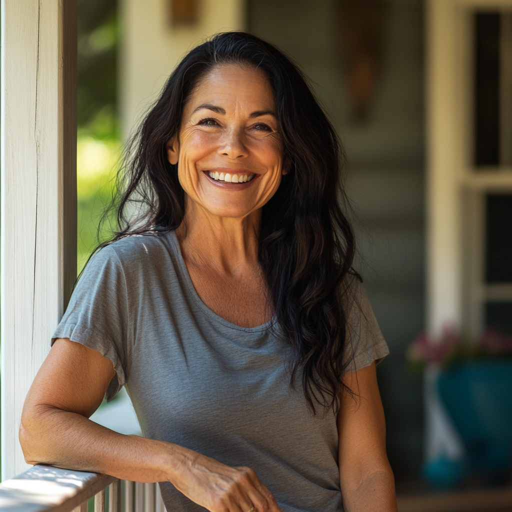 A smiling woman on her porch | Source: Midjourney