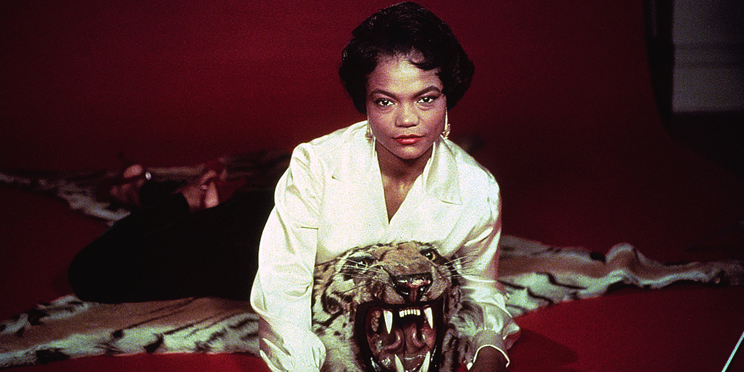 Eartha Kitt lying on a tiger carpet. | Source: Getty Images