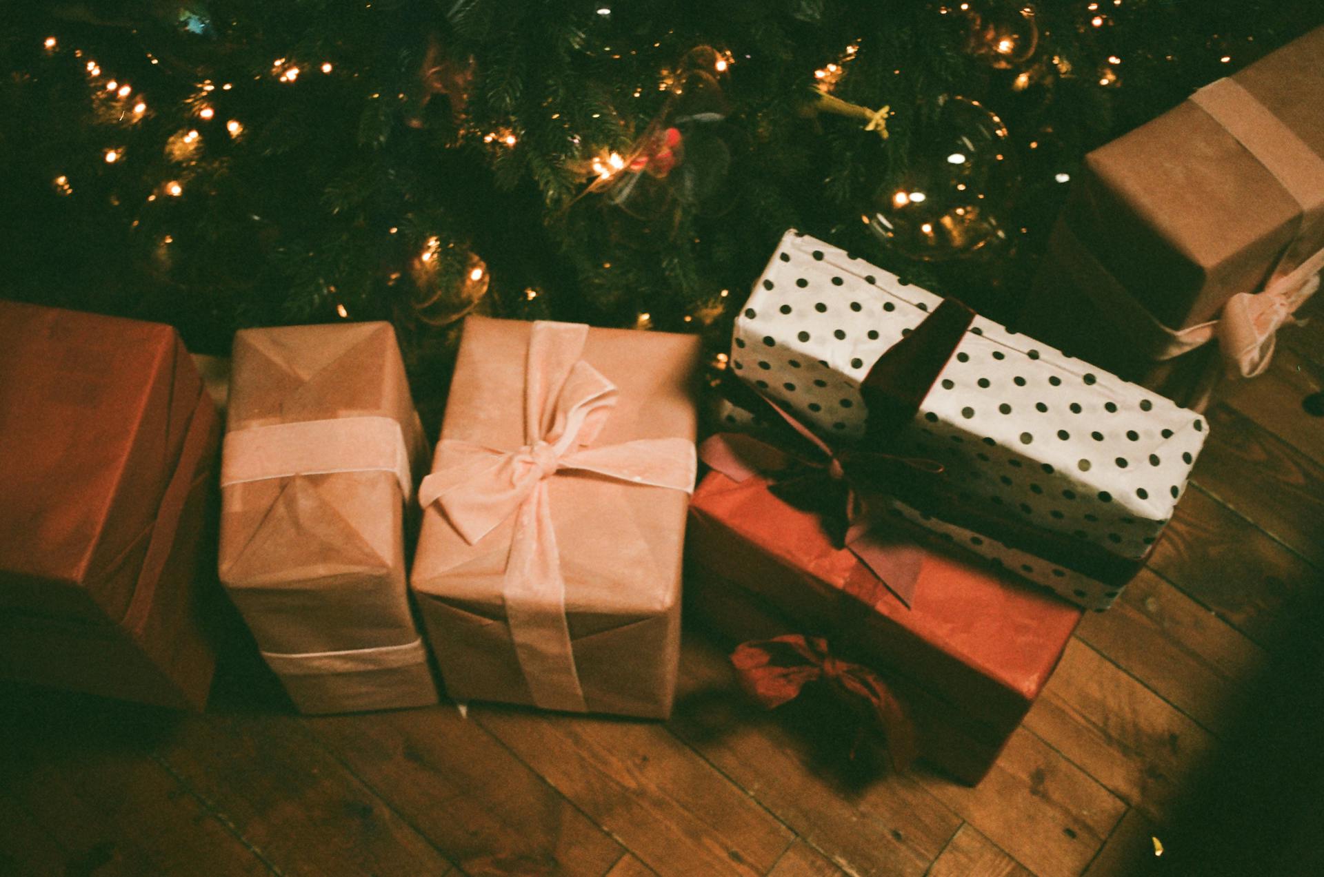 Assorted gift boxes on the floor near a Christmas tree | Source: Pexels