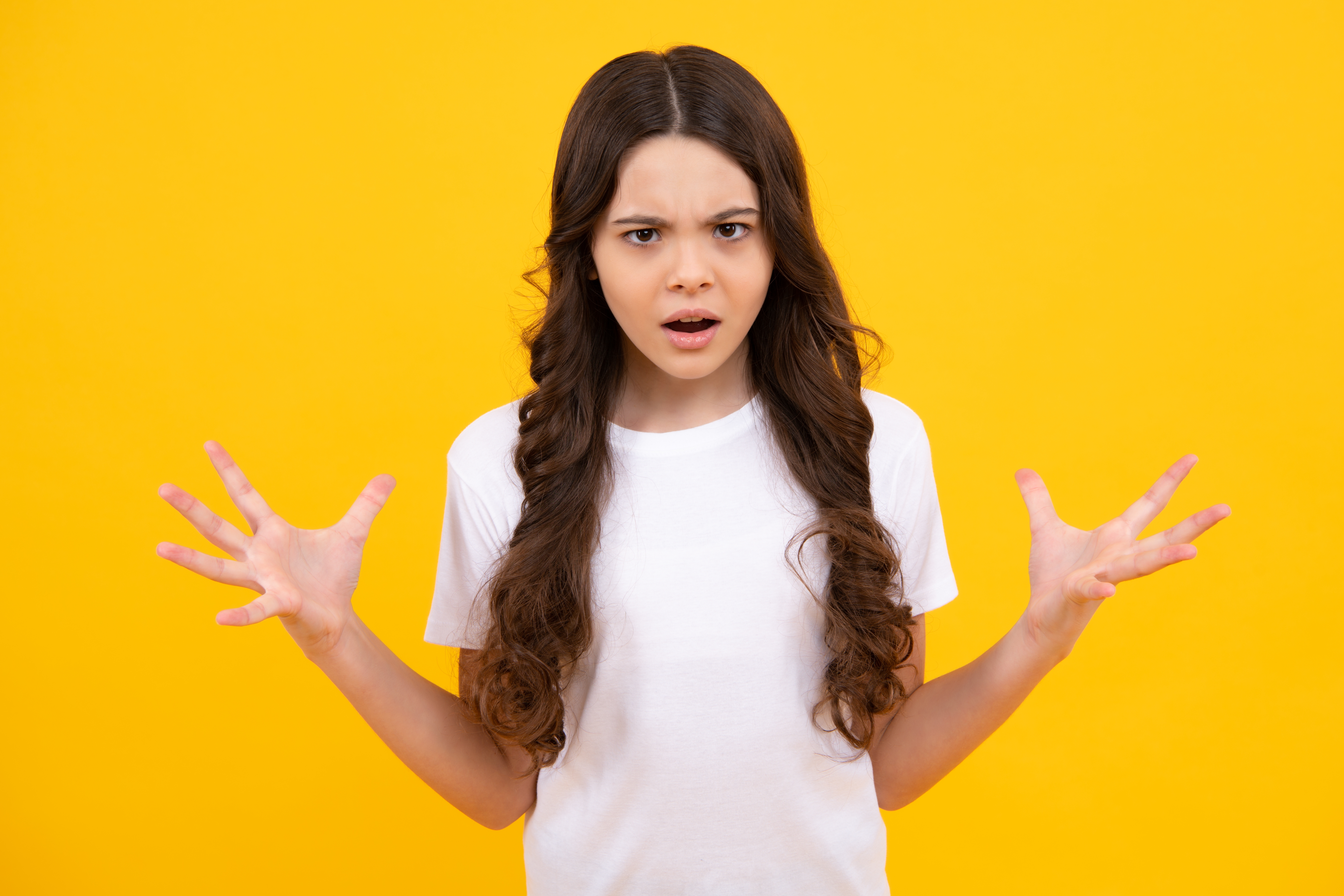 Teenage girl looking shocked and angry | Source: Shutterstock