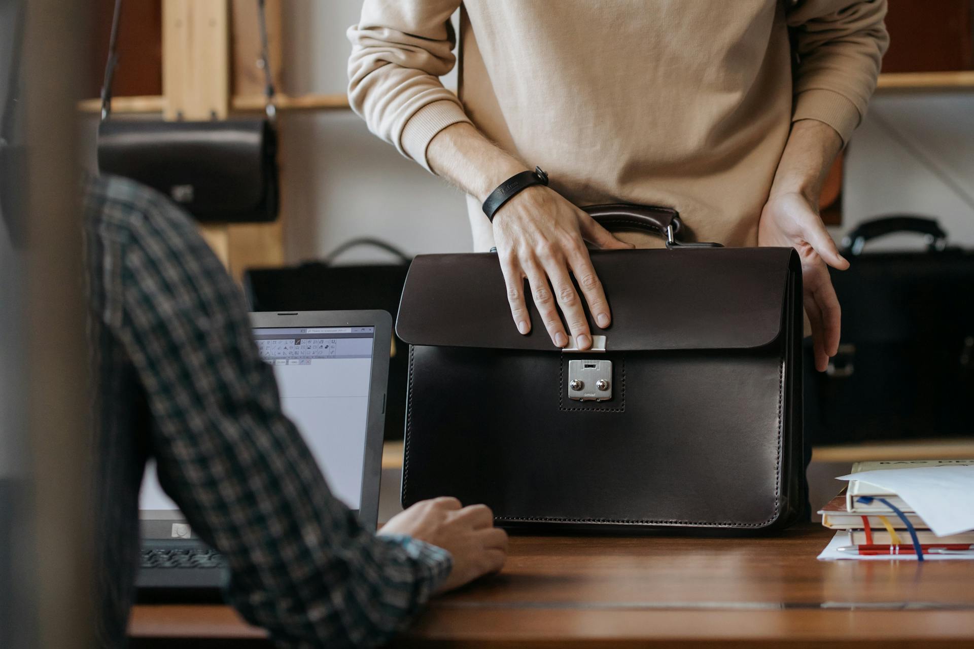 Man placing his black briefcase on the table | Source: Pexels