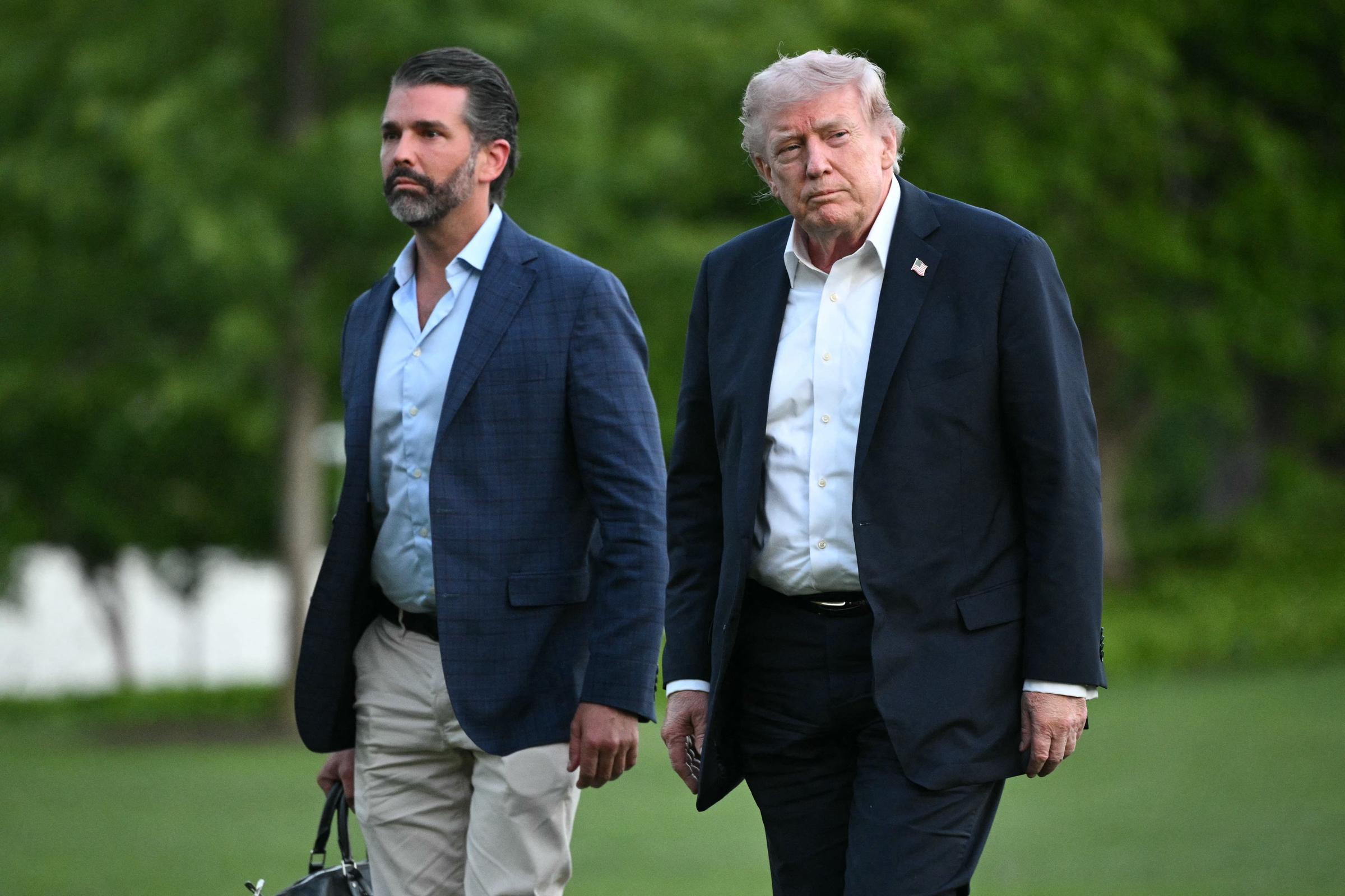 US President Donald Trump and Donald Trump Jr. walk on the south lawn toward the White House in Washington, DC, on May 3, 2026 | Source: Getty Images