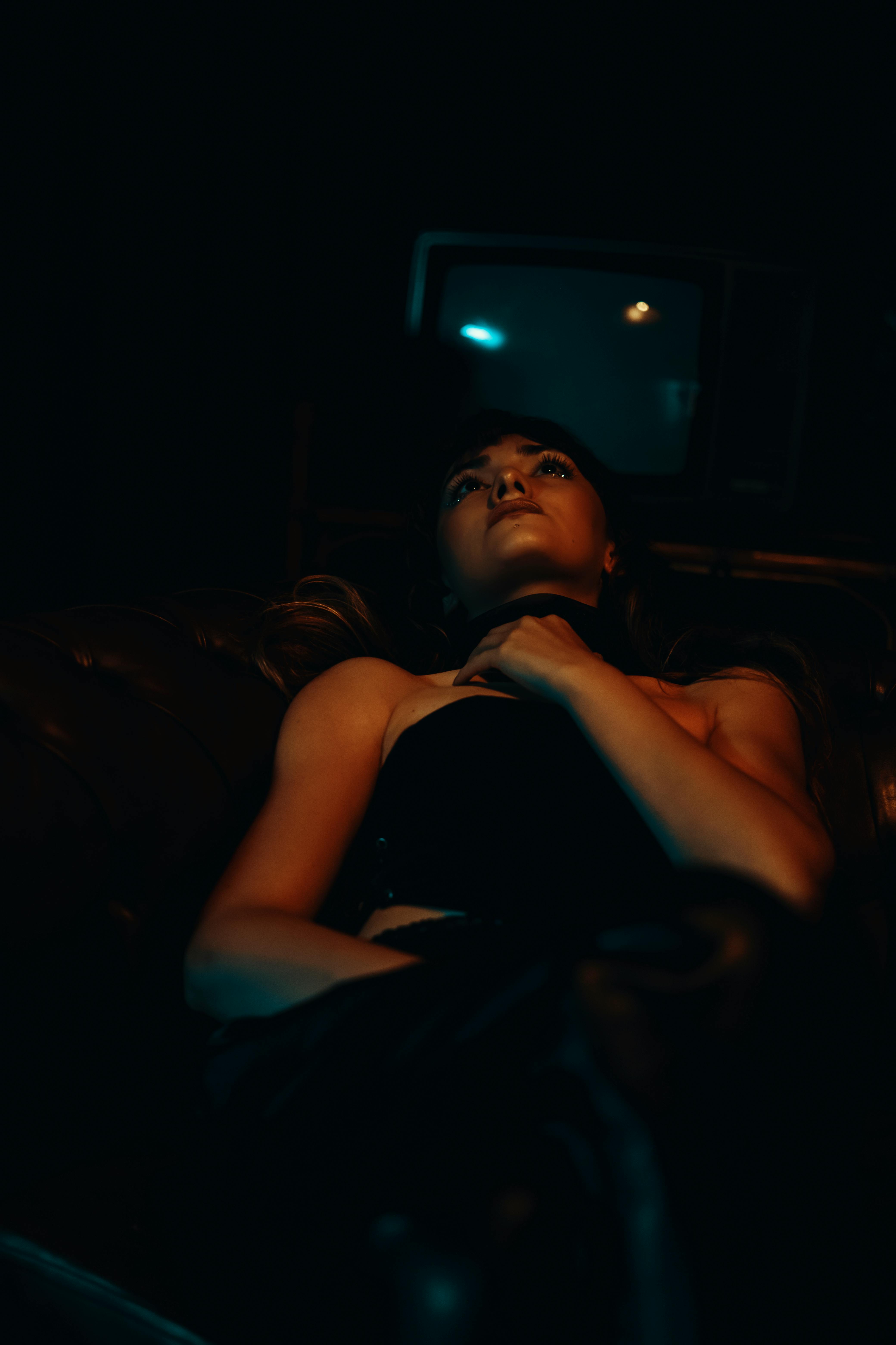 An emotional woman in a dark room | Source: Pexels