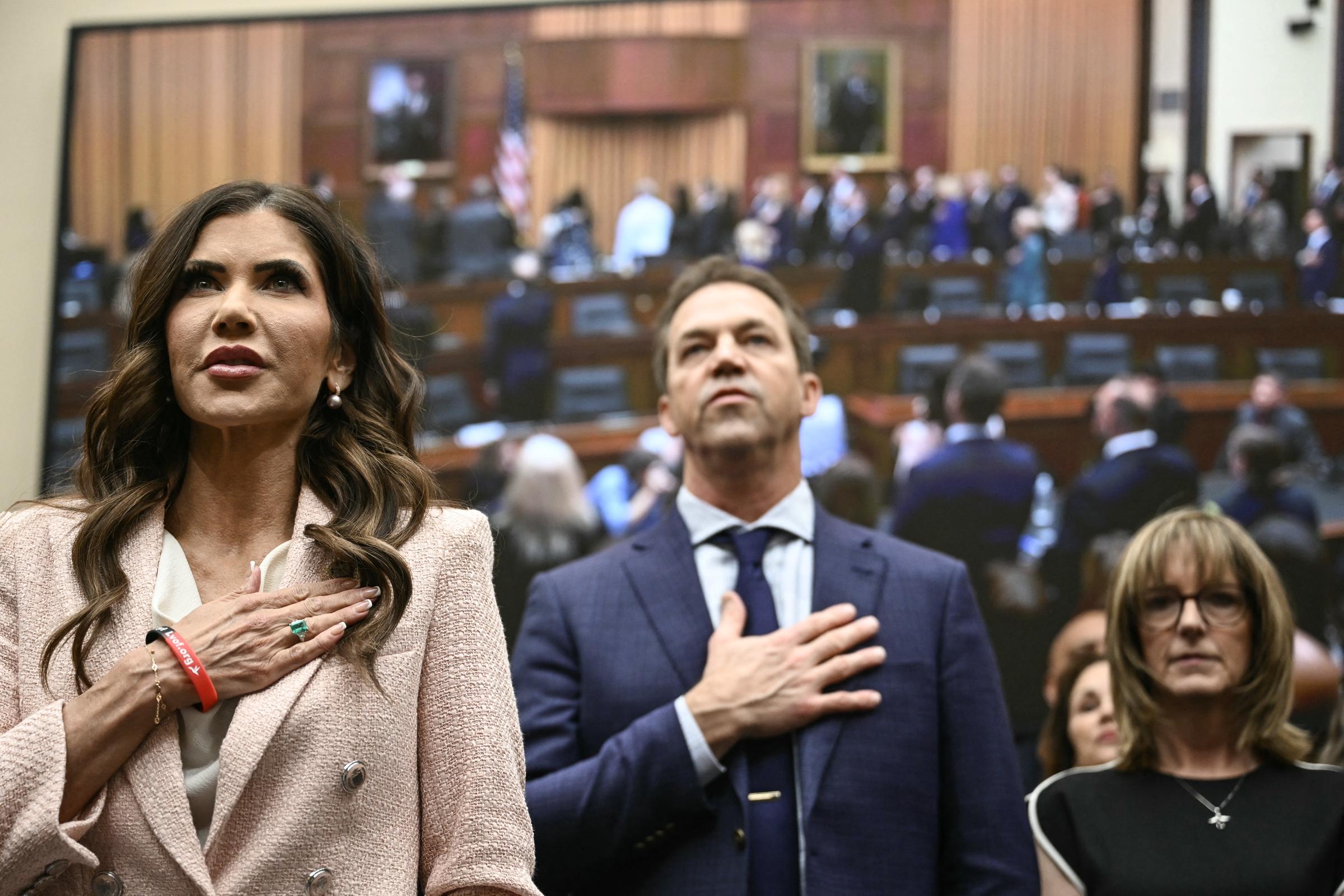 Kristi and Bryon Noem stand for the US Pledge of Allegiance at the start of a House Judiciary Committee hearing on March 4, 2026 | Source: Getty Images