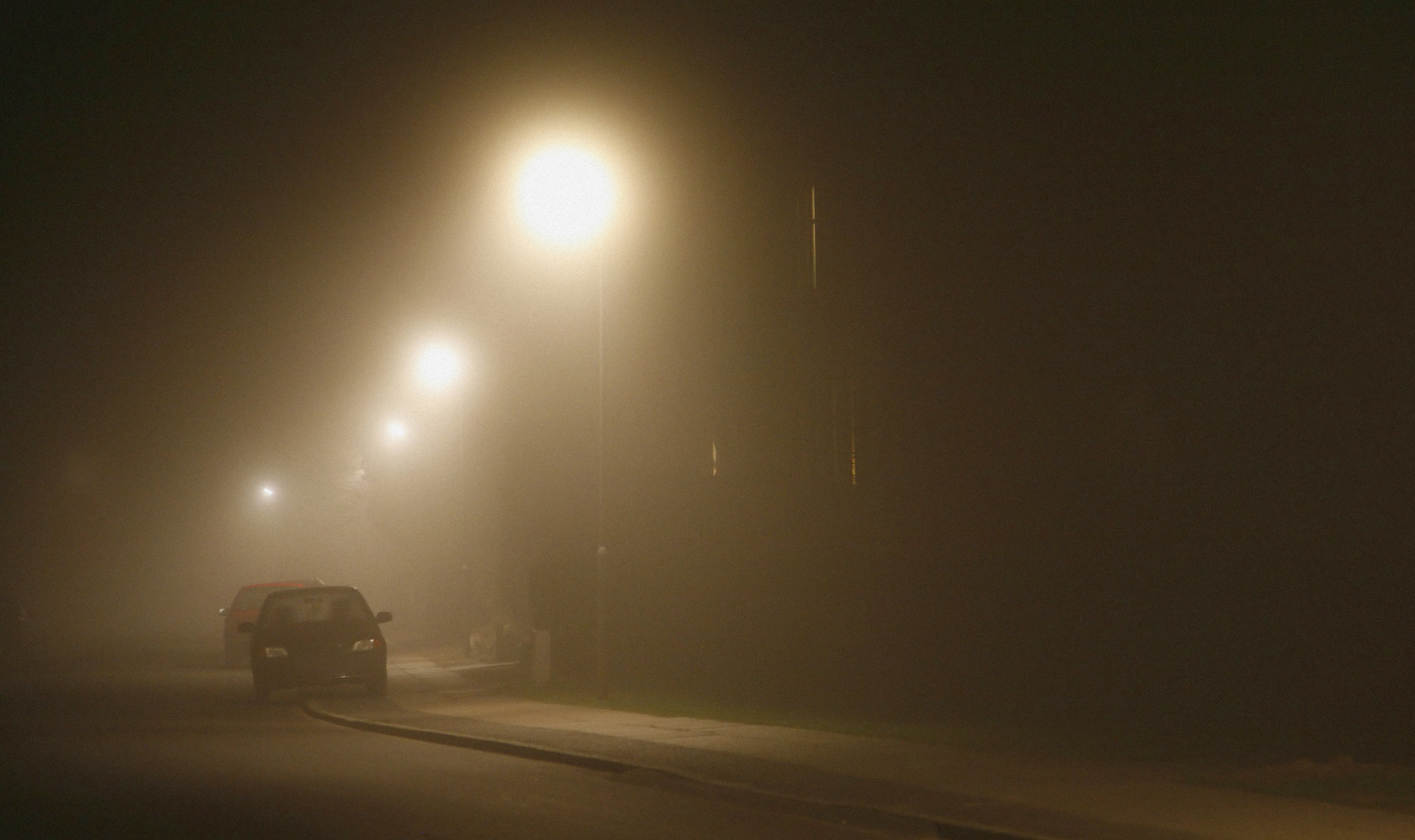 Car parked near the house at night on the street. | Source: Shutterstock