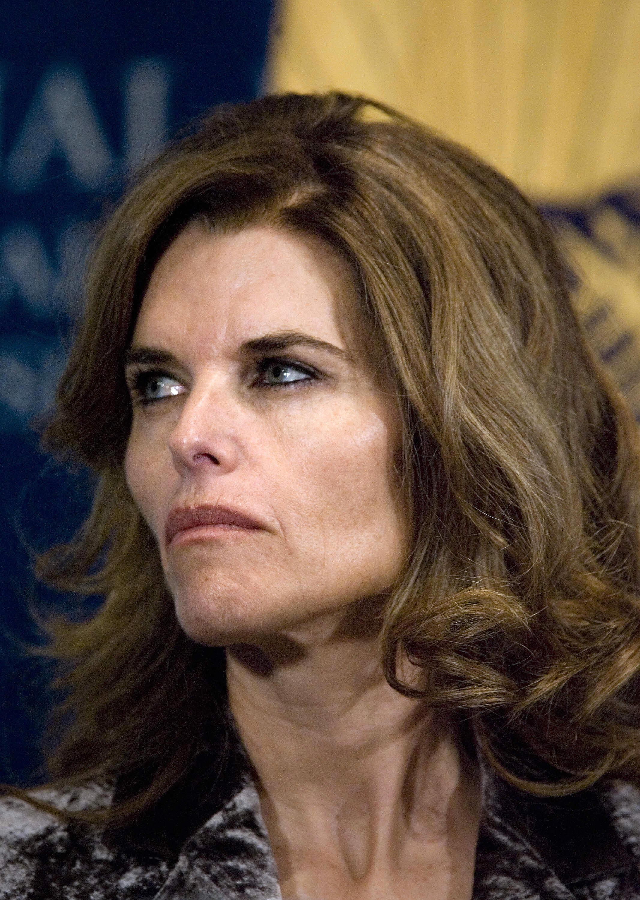 Maria Shriver, the wife of California Governor Arnold Schwarzenegger, looks over while he speaks at the National Press Club 26 February 2007 in Washington, DC. | Source: Getty Images